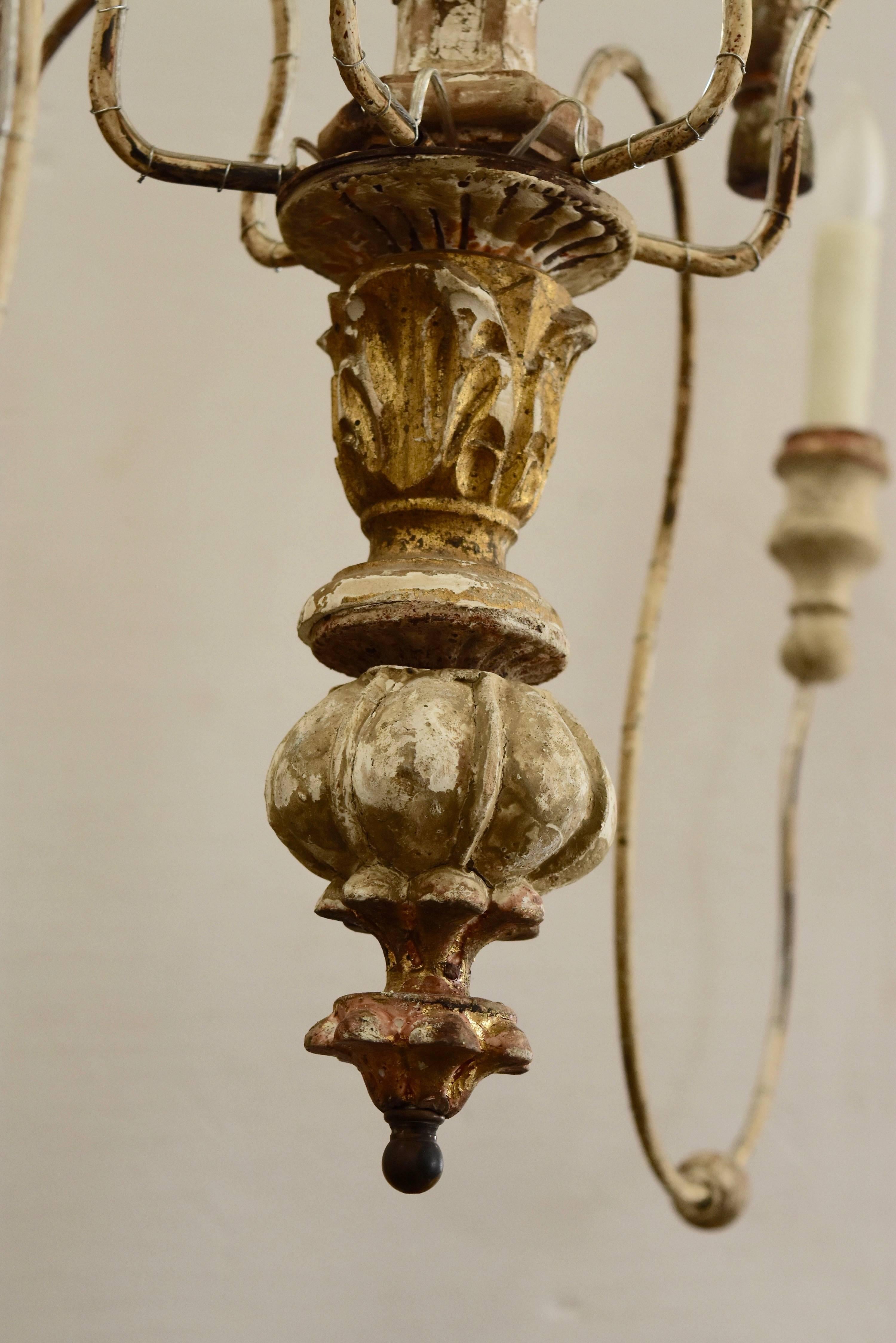 This chandelier is newly made from 18th century and newer altar elements, iron and newly wire for USA standard. It has chipped paint of white and gold gilt, gilt tassels, painted white and gold bobeches. Lovely when you want that airy feel. It's
