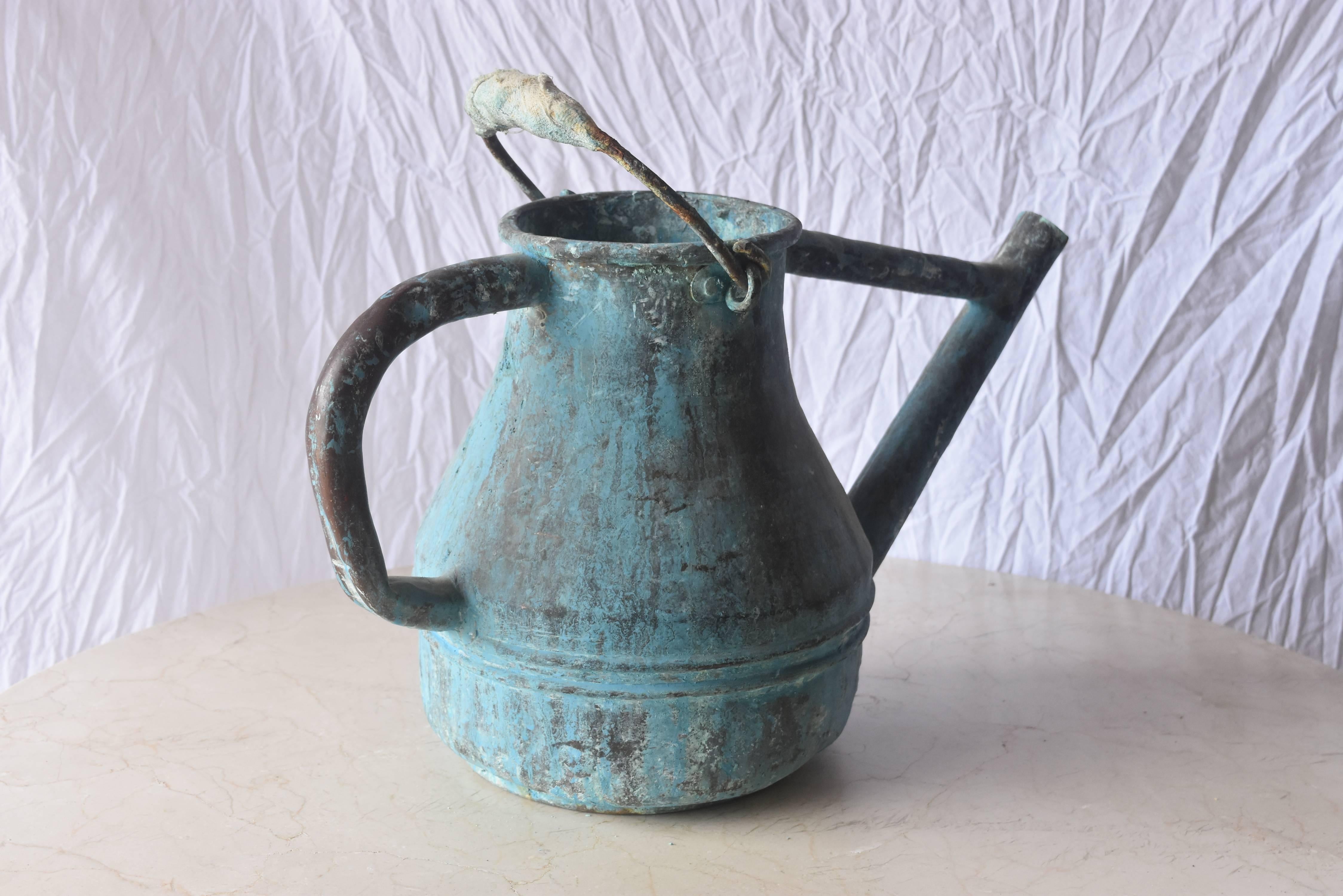 This is not your run of the mill watering can. It's unique, large-scale, copper one from France. It is totally intact, heavy duty and useable today. The patina is especially desirable and makes a colorful, decorative garden piece as well.