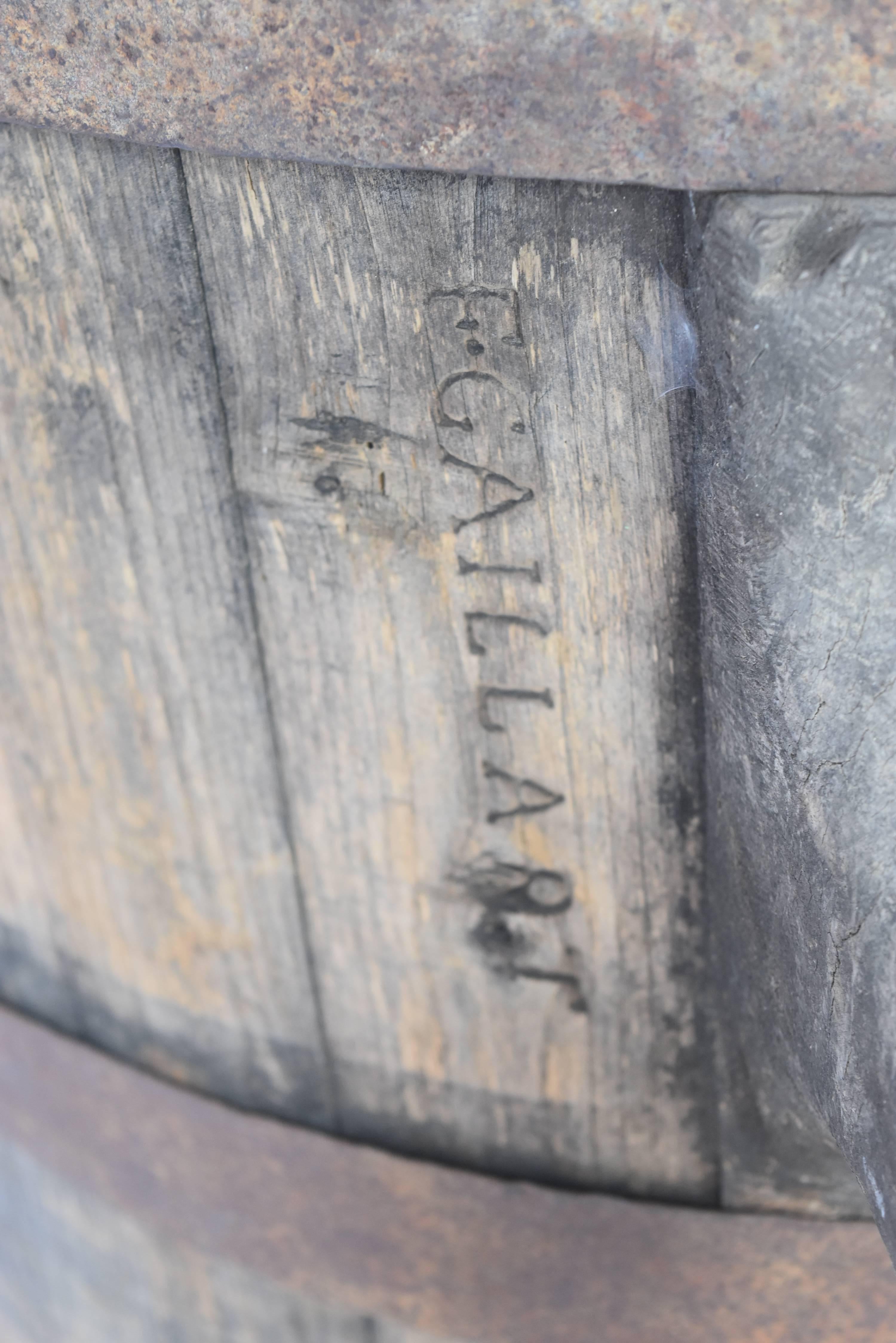 These are large-scale French wine barrels from Europe that have stamped F. Gaillart. They are wooden, have wooden handles and metal straps that hold them together. They are the perfect size for small fruit trees, or great to put a wood or marble top