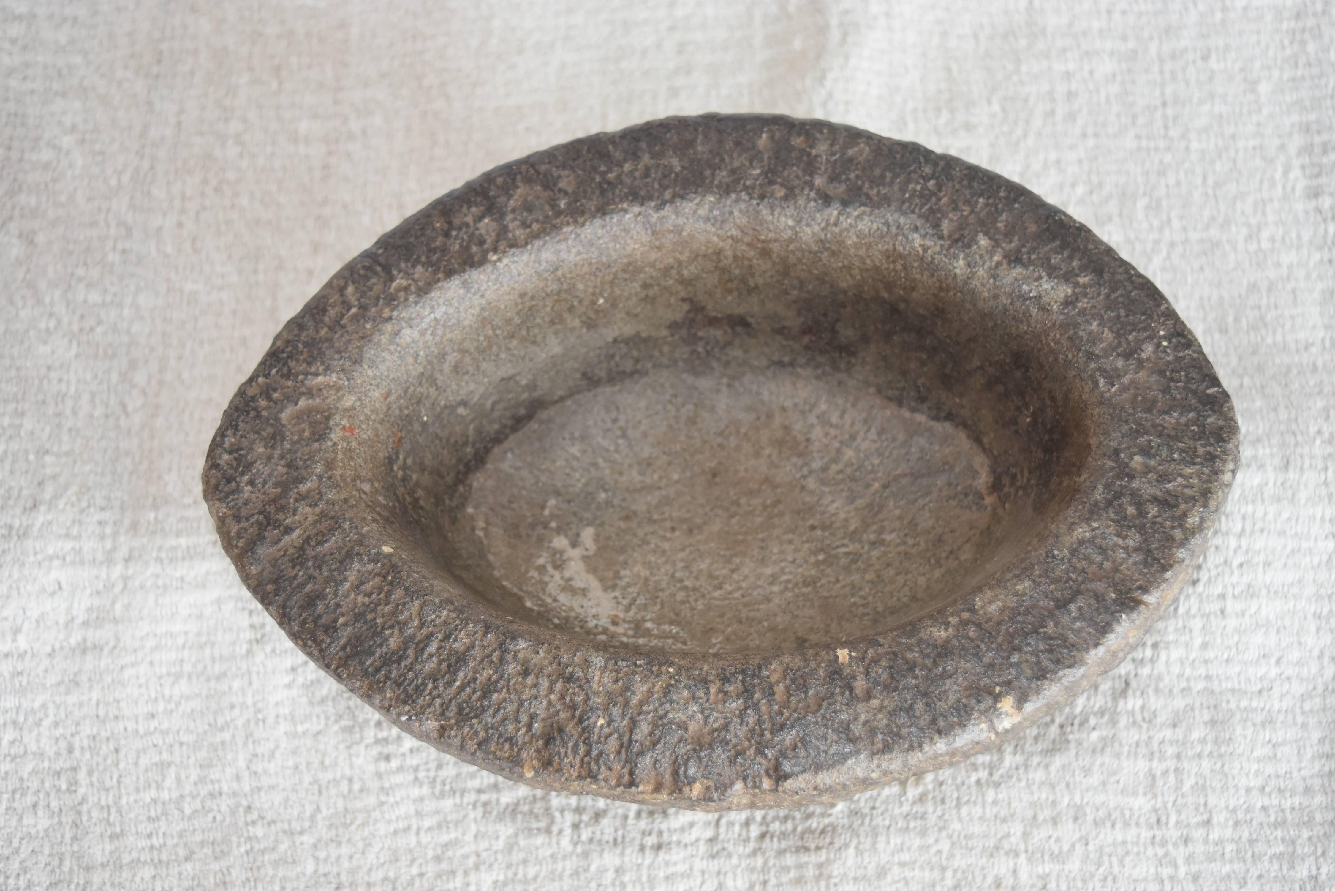 This bowl from India is charcoal gray stone that appears to be granite. It's very heavy for a small bowl, about 20lbs.
I love them for serving nuts, dips or just as a beautiful decoration on a table.