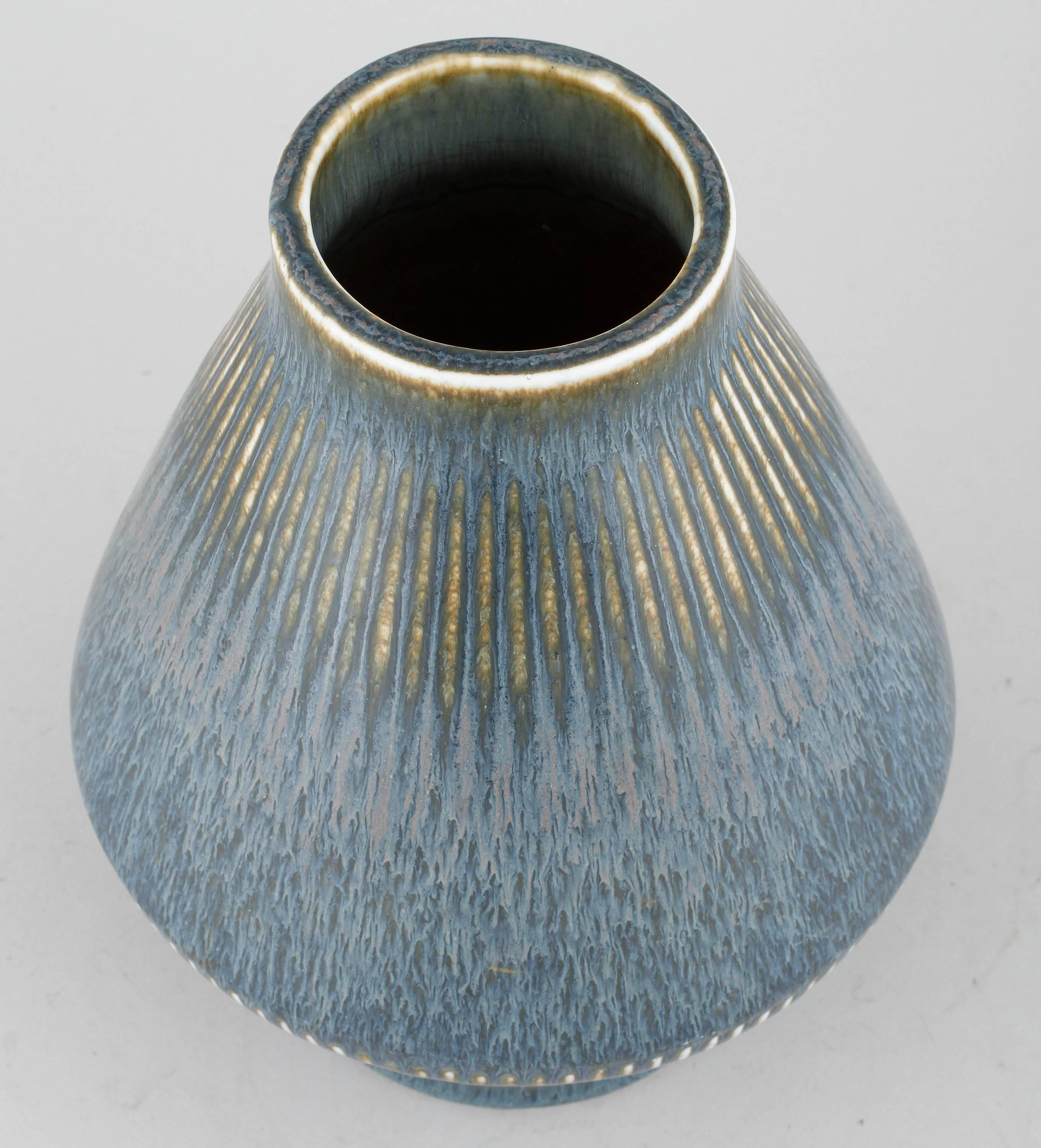 Beautiful vase created by Carl-Harry Stalhane for Rörstrand, signed under the base.
The glazed is a vibrant washed blue with traces of brown and ochre and a touch of white on the edges.
Very good condition without any chips, only regular wear due