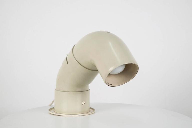 Model 602 adjustable table lamp designed by Cini Boeri for Arteluce in 1968. PVC and white lacquered metal structure with turnable arm. Original Arteluce decalcomania on the internal part of the diffuser.