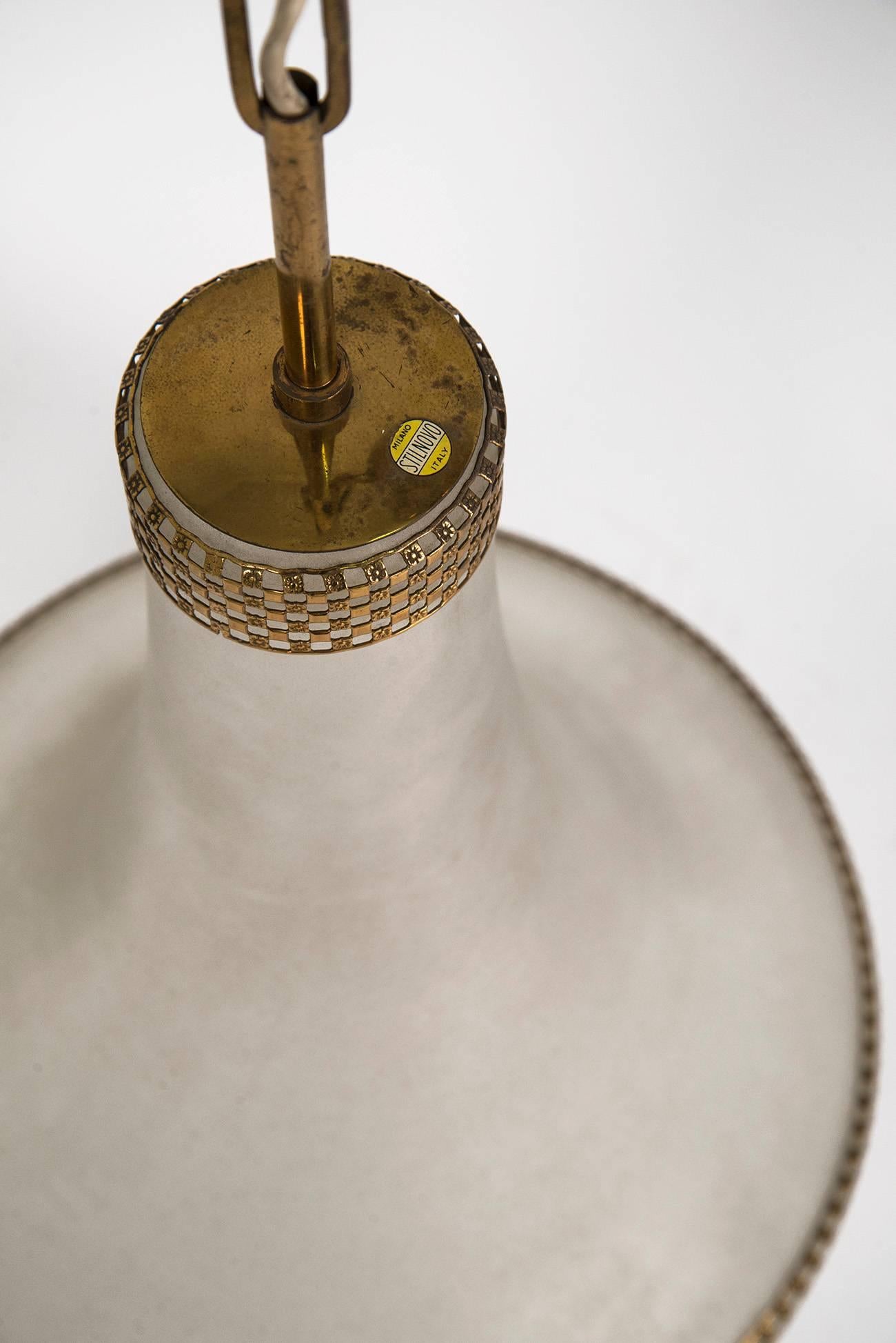 Pendant with a frosted glass diffuser and elegant brass crowns decorations, manufactured by Stilnovo in the 1950s. Original manufacturer's decalcomania on the upper part of the shade.