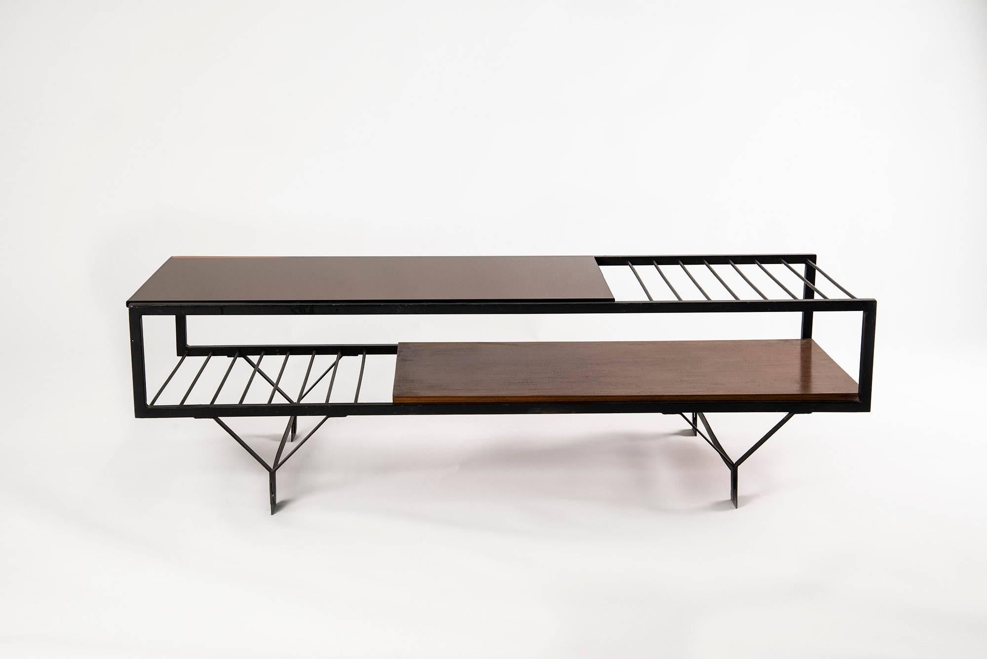 Large low table manufactured in Italy in the late 1950s. Black lacquered iron structure, wooden lower tray, mirrored orange glass top. Good original conditions.