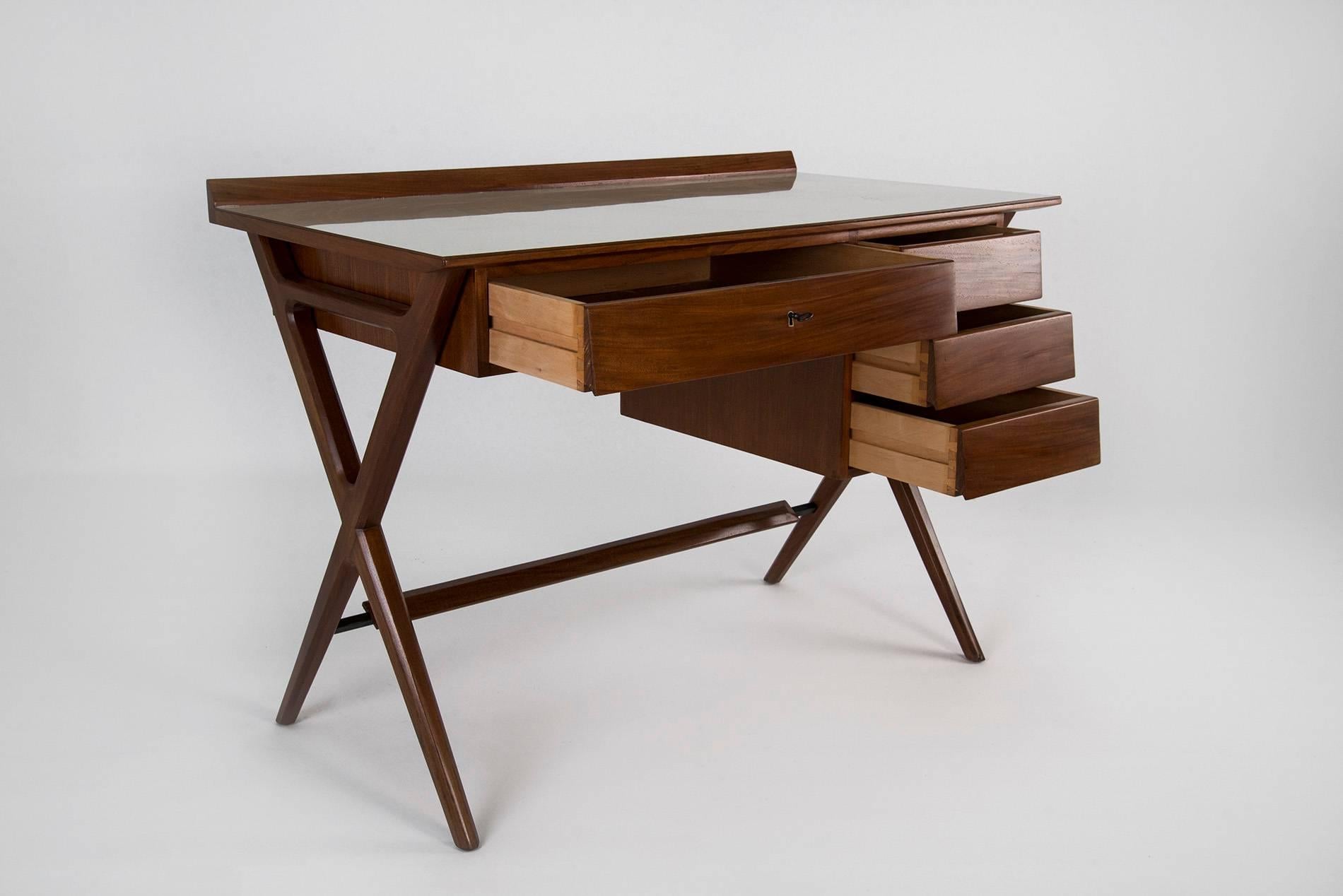 Pair of desks manufactured in Italy in the 1950s. Mahogany structure with a formica top, four drawers (the central one can be locked). Completely restored.