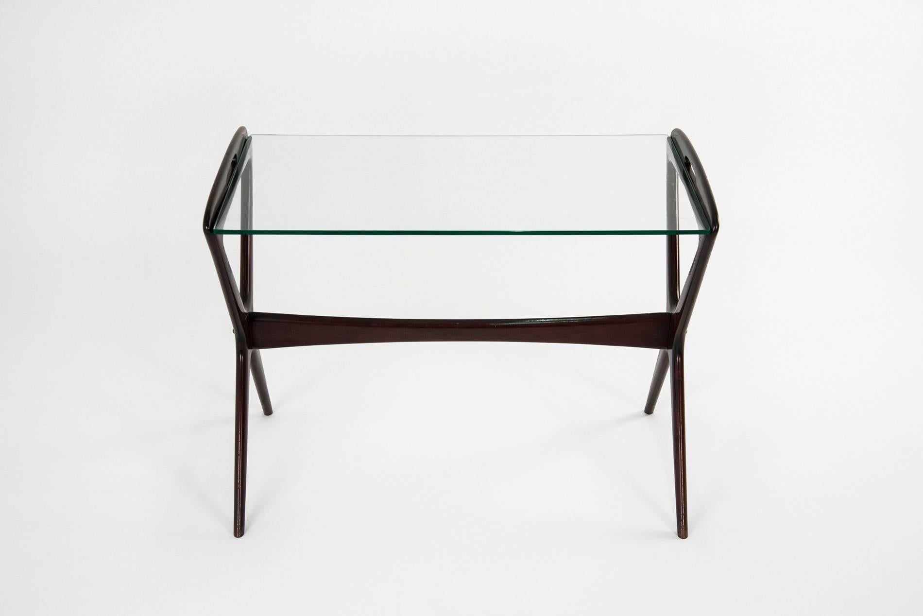 Ico Parisi for Angelo De Baggis Low table featuring a sleek design, manufactured in Italy in the 1950s. Lacquered wooden structure with handles which easily permit to carry it around, glass top, brass screws. Good original vintage conditions.