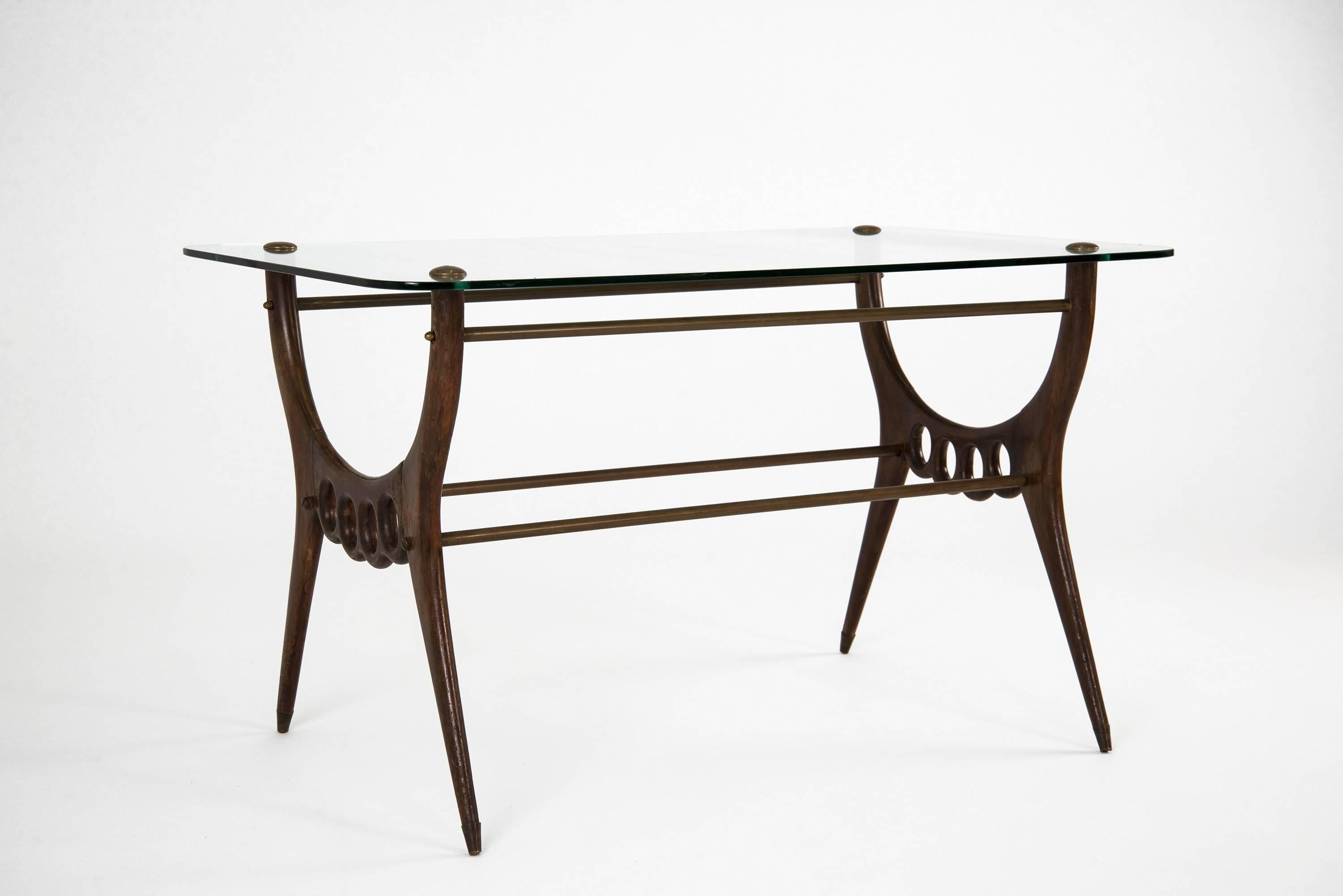 Elegant low table manufactured in Italy in the 1950s. Wooden structure, brass beams, glass top. Good vintage conditions.