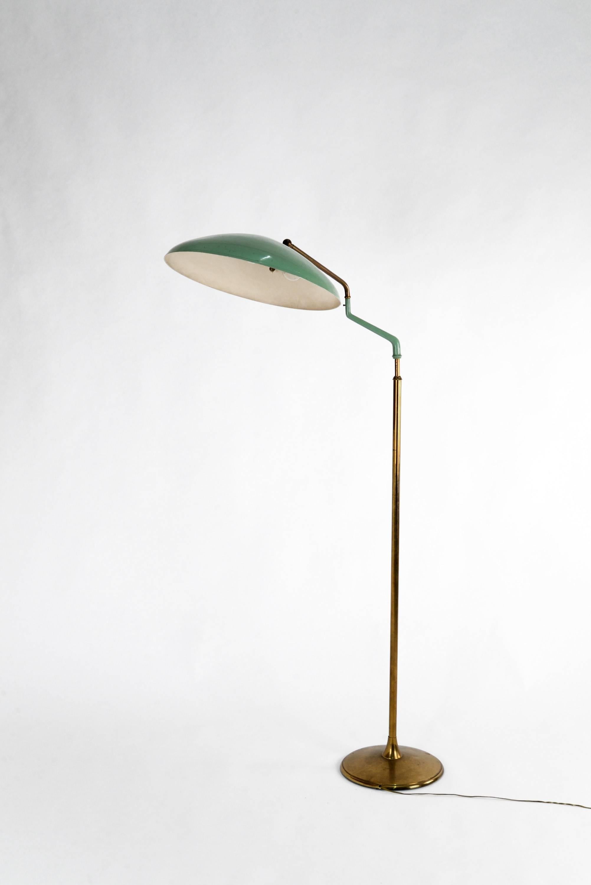 Elegant and rare adjustable floor lamp manufactured by Lumi in the 1950s. Brass base, stem and joints, green lacquered metal shade. Good original vintage conditions, charming patina. Adjustable height.