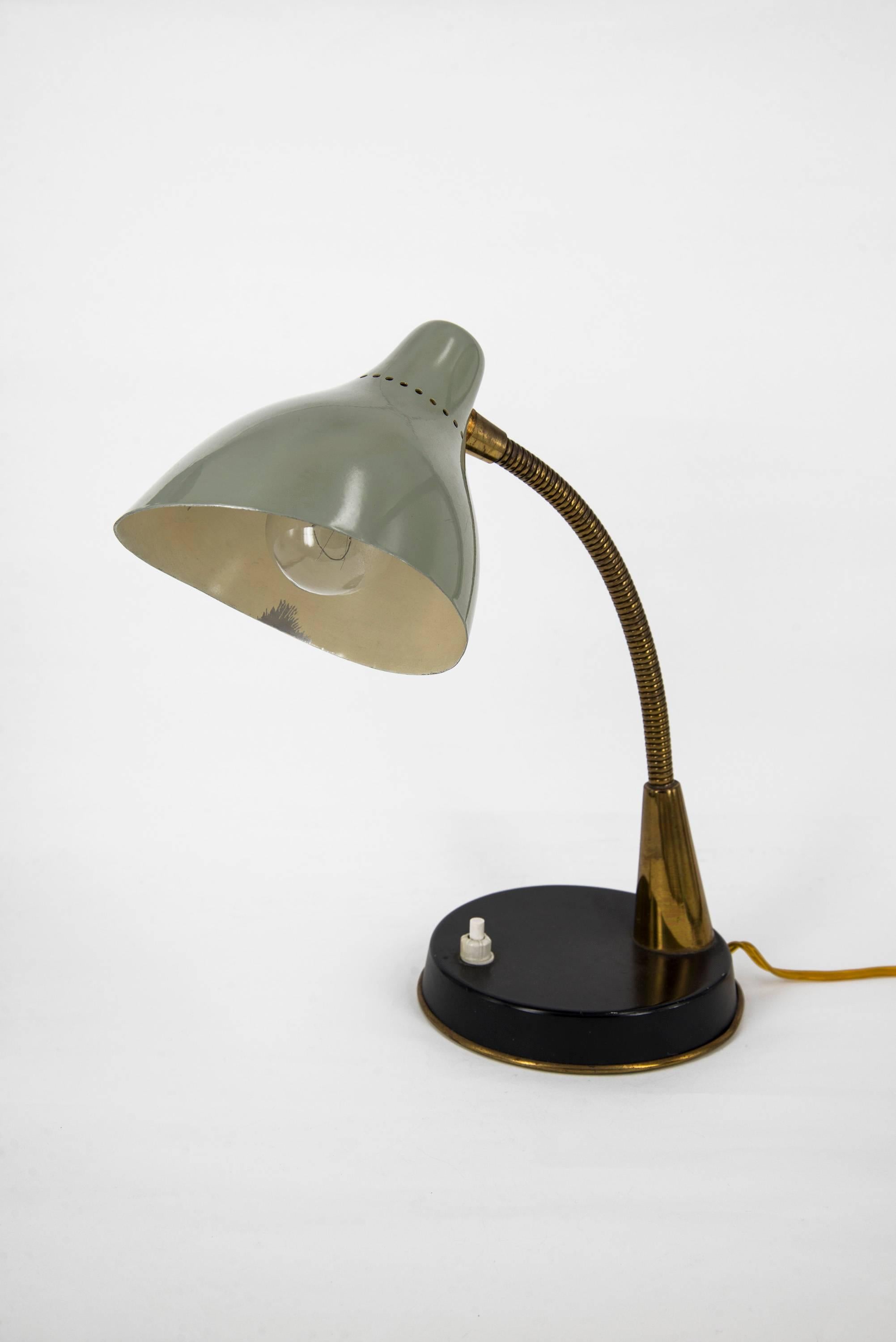 Flexible and adjustable pair of table lamps manufactured by Oluce in the 1950s. Lacquered metal bases, flexible brass stem, lacquered metal diffusers. Good original vintage conditions.