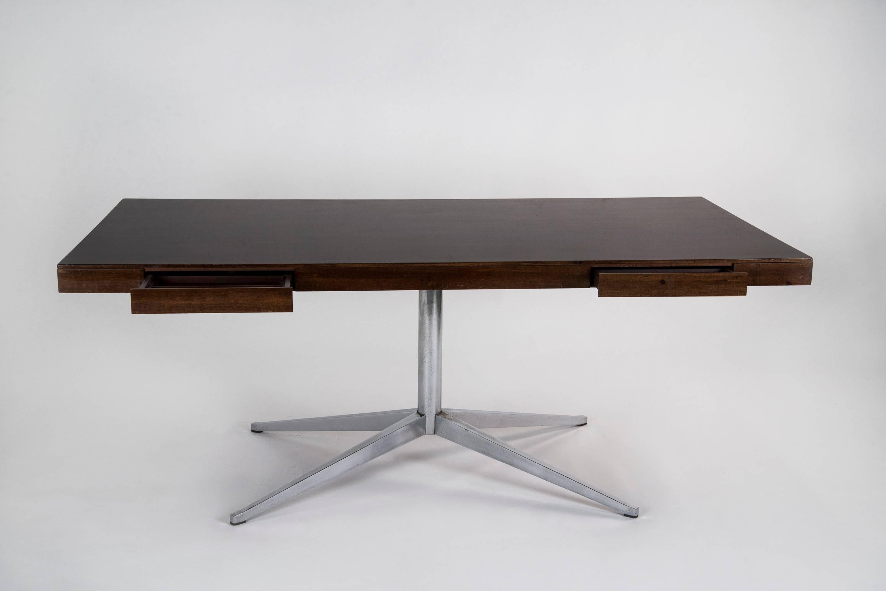 Extraordinary executive desk designed by Florence Knoll for Knoll in 1961. Chrome-plated steel base, massive walnut top with two drawers on both sides. Good original vintage conditions.