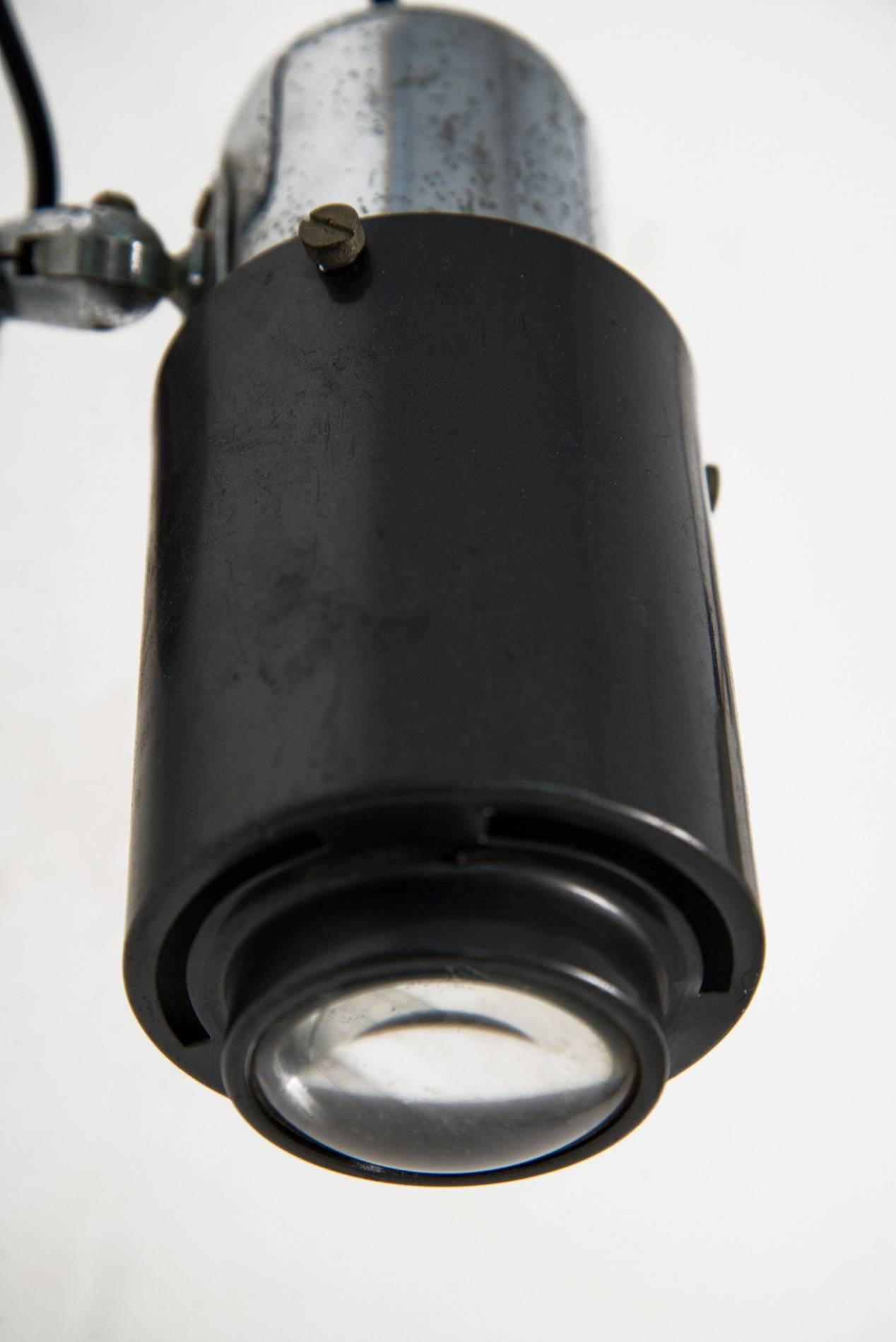 Adjustable wall light designed by Jacques Biny for Lita, France, in the 1950s. Black lacquered and nickel plated structure, glass lens. Good original vintage conditions.