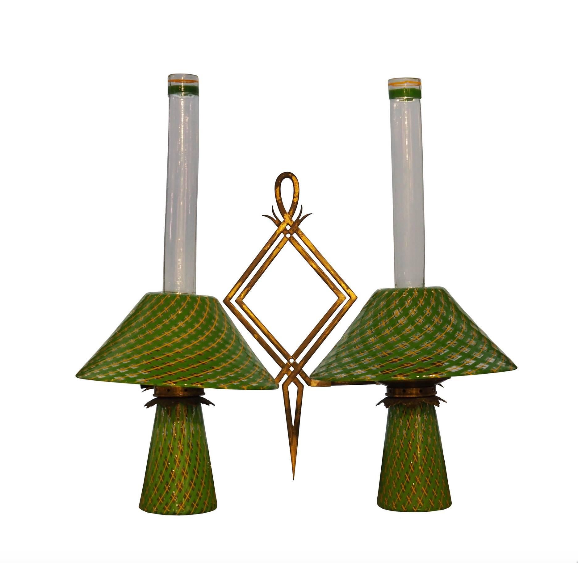 Pair of appliques designed by Flavio Poli and produced by Seguso Vetri d'Arte in 1950s. Each piece is composed by two lamps on a brass frame. The execution of “reticello” glass is really exquisitely done, so the object looks very sophisticated and