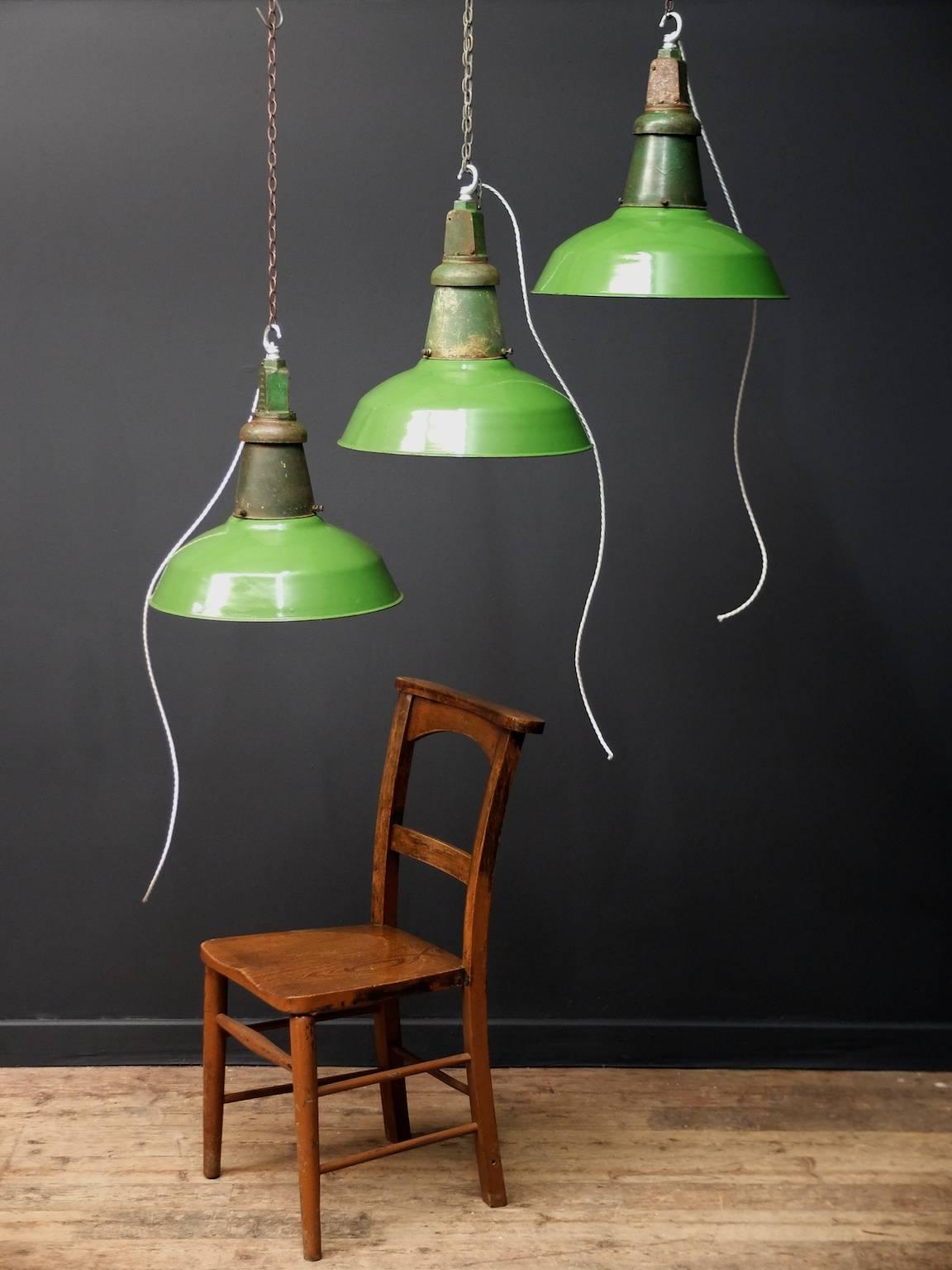 A large run of green enamel industrial pendant lights.

English 1940s.

47 available price is per pendant.

Rewired and pat tested, supplied with suspension chain and ceiling hook.