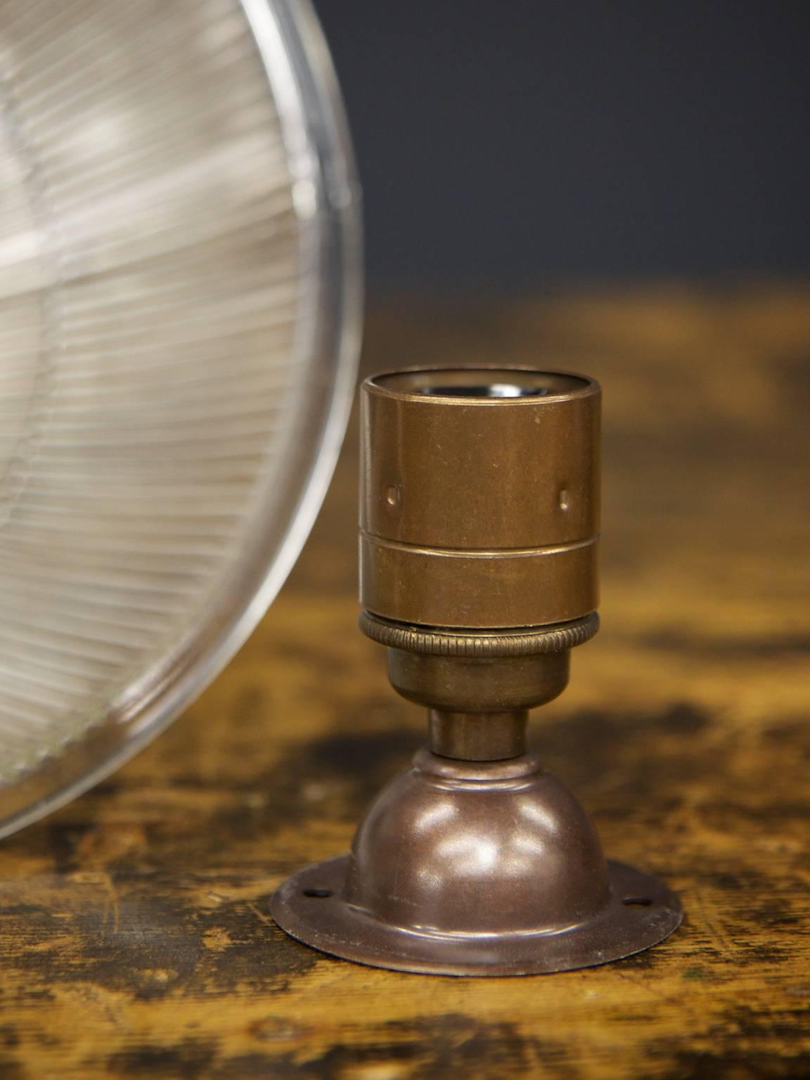 A ceiling mounted Holophane prismatic shade with bronzed adjustable mount.

English, 1930s.