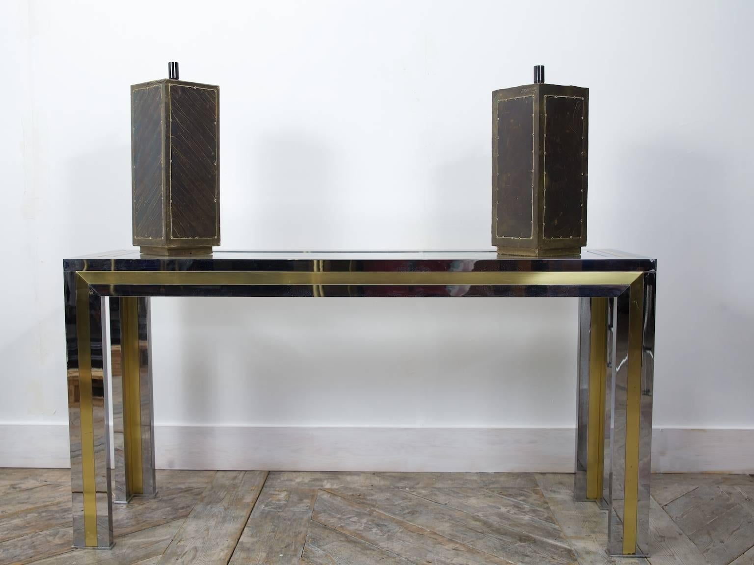 A pair of signed table lamps by Rodolfo Dubarry.

Timber blocks wrapped in patinated copper and brass,

Argentinian, 1970s.