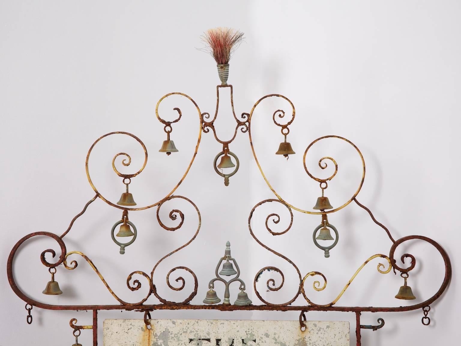 A double-sided hanging sign for the Cornwall Museum of Smuggling in Polperro, Cornwall.

The painted wrought iron frame with handwritten double sided alloy signage, numerous brass bells and spring or brush decoration to the top.

A wonderful