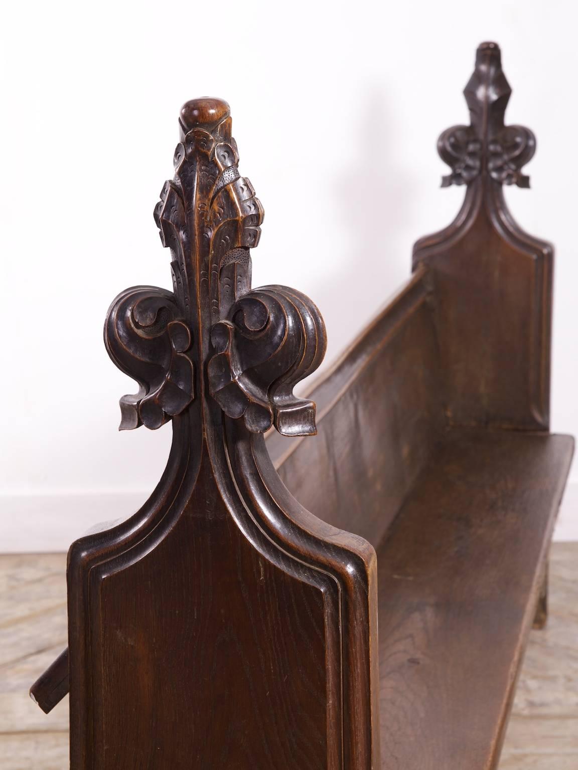 A 18th century oak church pew.

The seat and back rest are single thick oak planks as are the carved end supports,

Norfolk, 1760s.