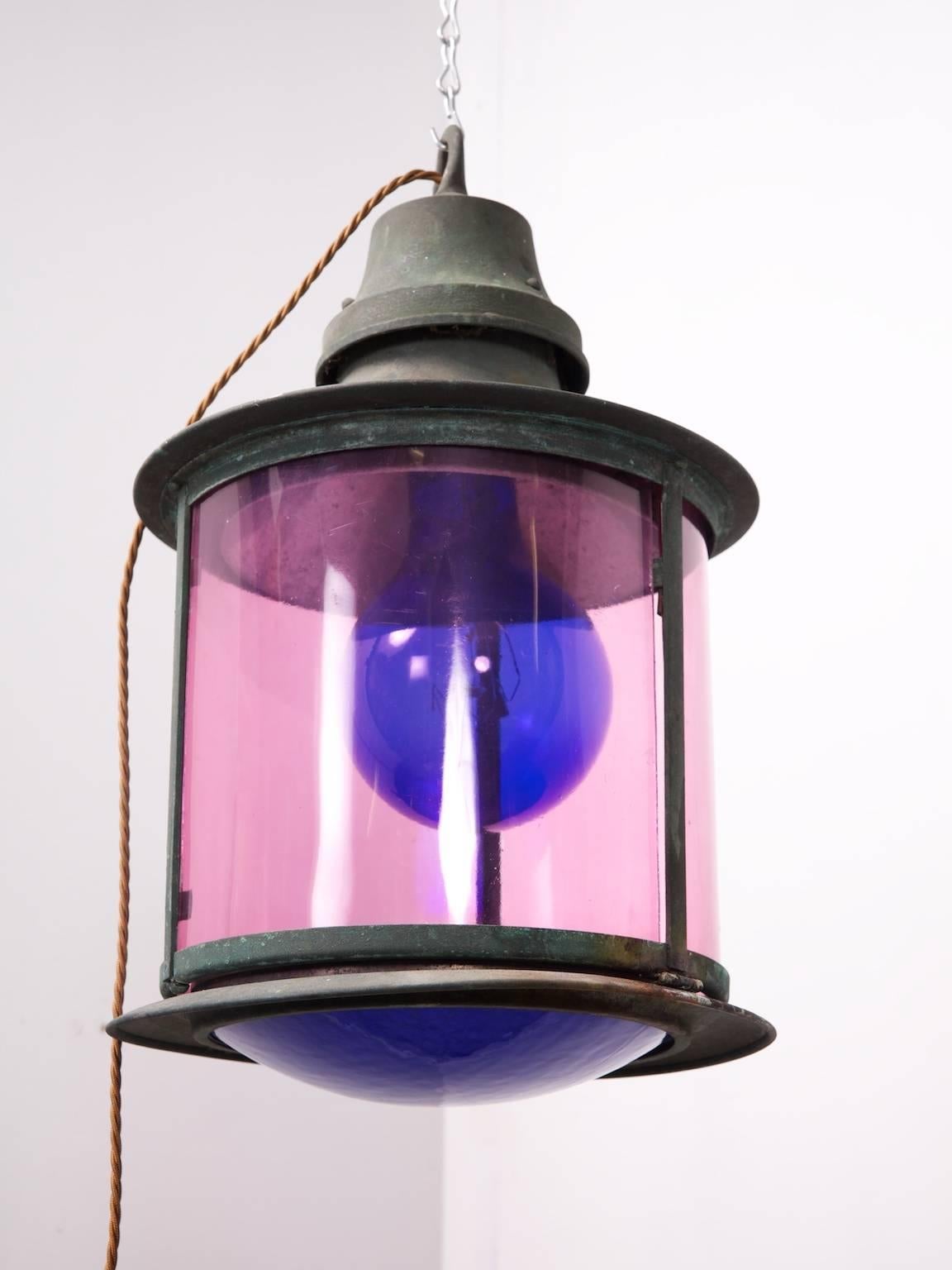 A cylindrical copper lantern with extremely unusual and colorful glazing.

English, second half of the 19th century.

Rewired and pat tested.

Additional blue glass panels.