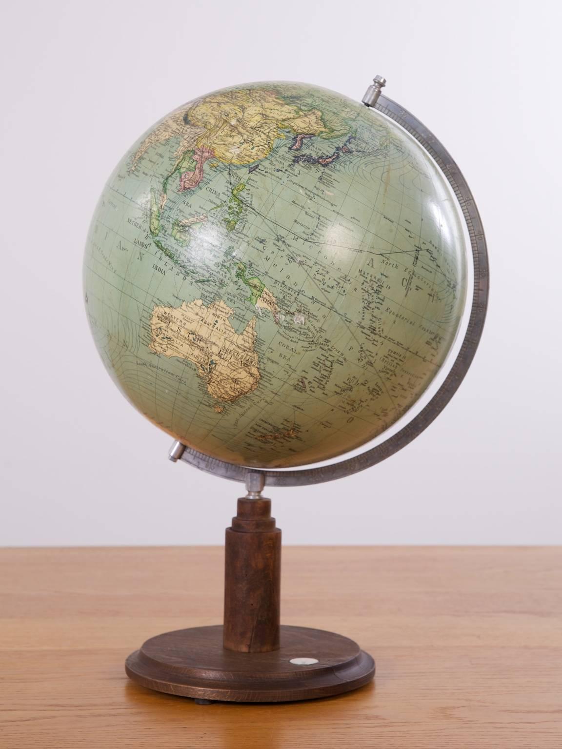 A terrestrial desk globe on alloy and mahogany mount with integral compass.
 