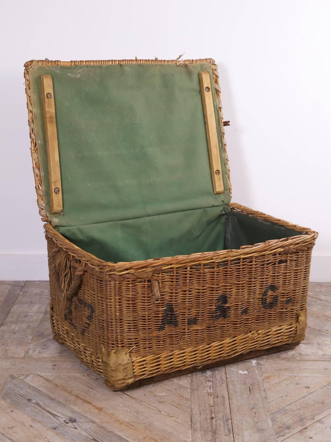 A wicker laundry basket.

Rope handles, inset castors to the base, folding canvas liner to the interior.

English, early 20th century.