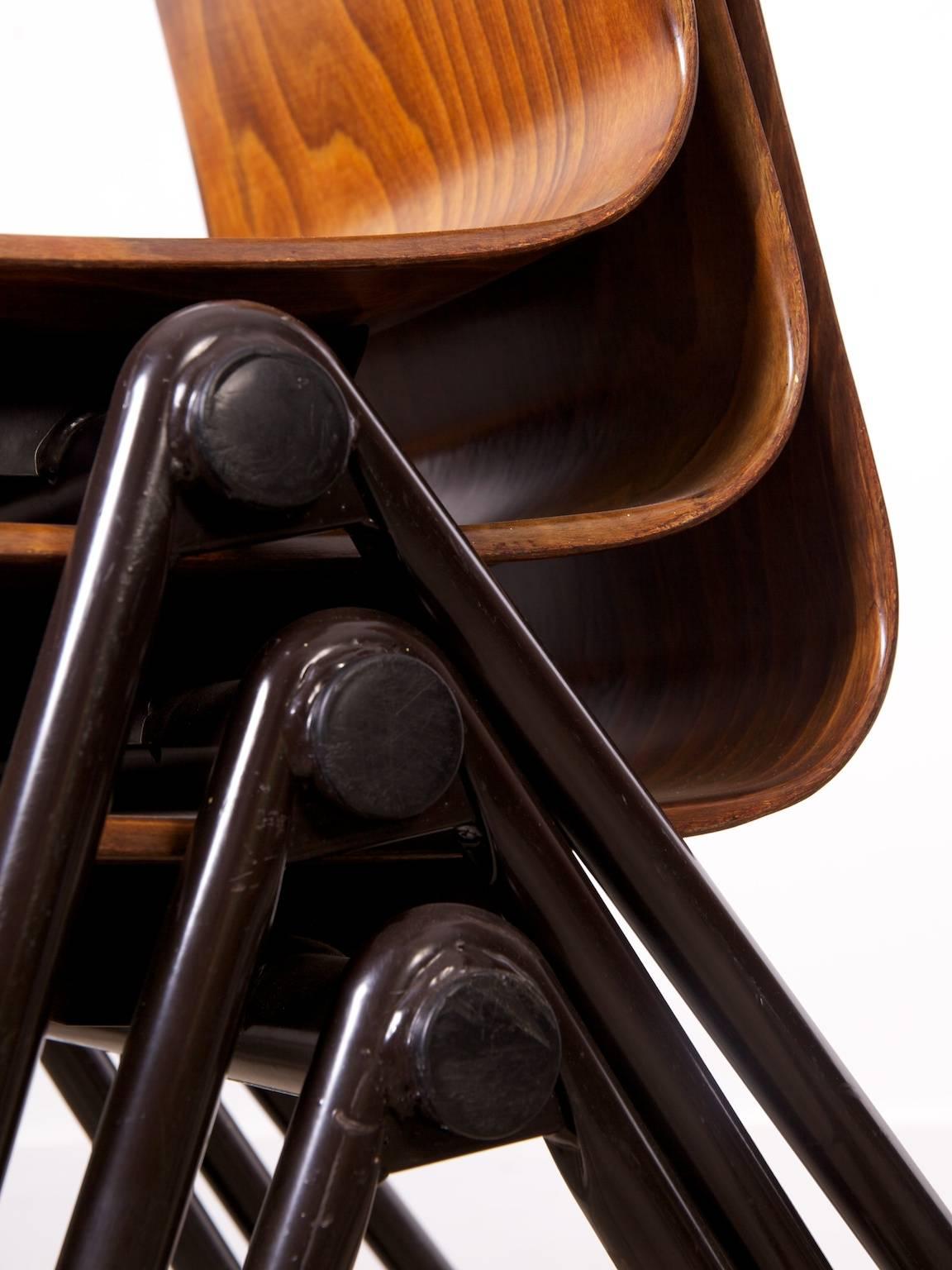 Six hairpin legged stacking chairs with moulded resin and timber seats.

Thur-Op-Seat chairs with stackable metal frame. These Industrial school or dining room chairs were made at Galvanitas, Netherlands (see logo G). They were created because of