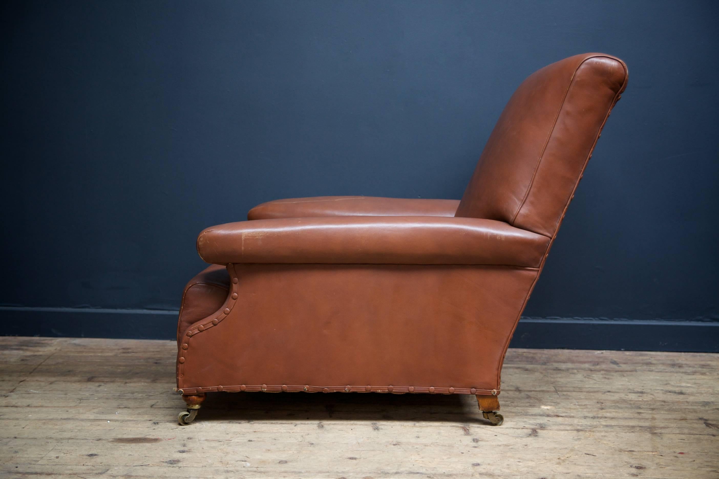 A brown leather low armchair by Howard & Sons, London,

English, 1870s.

 
