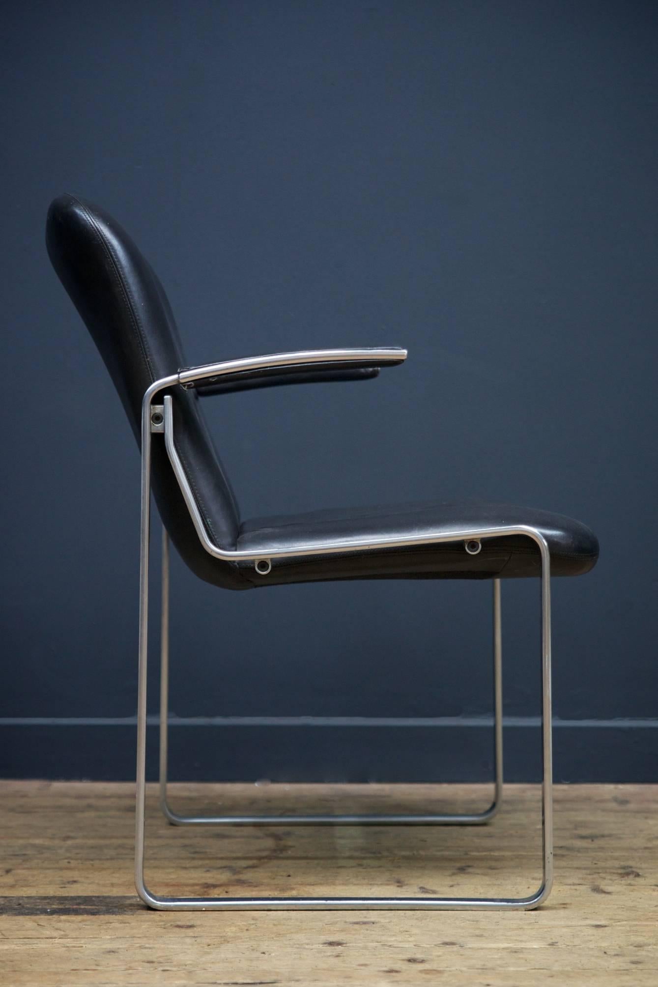 A pair of black leather and extruded alloy open armchairs, exceptional good quality.