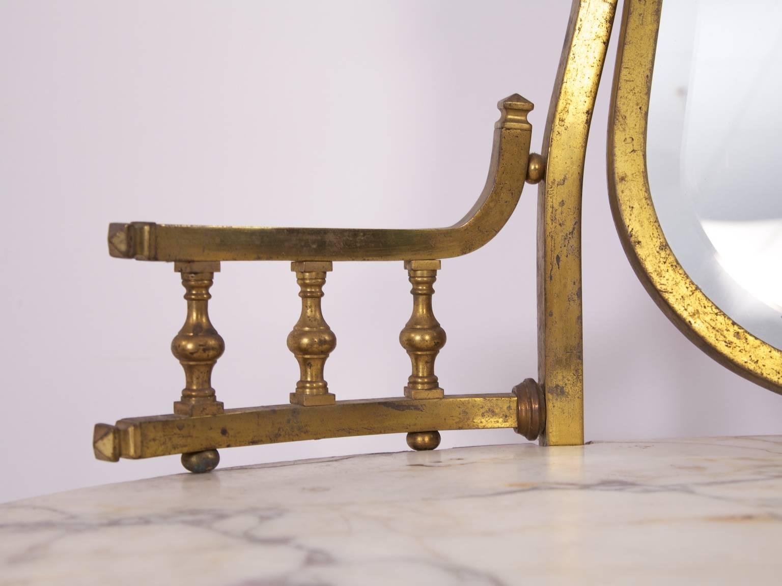 A brass dressing table with a Carrara marble top.

European late 19th century.

Old repair to the back of marble.