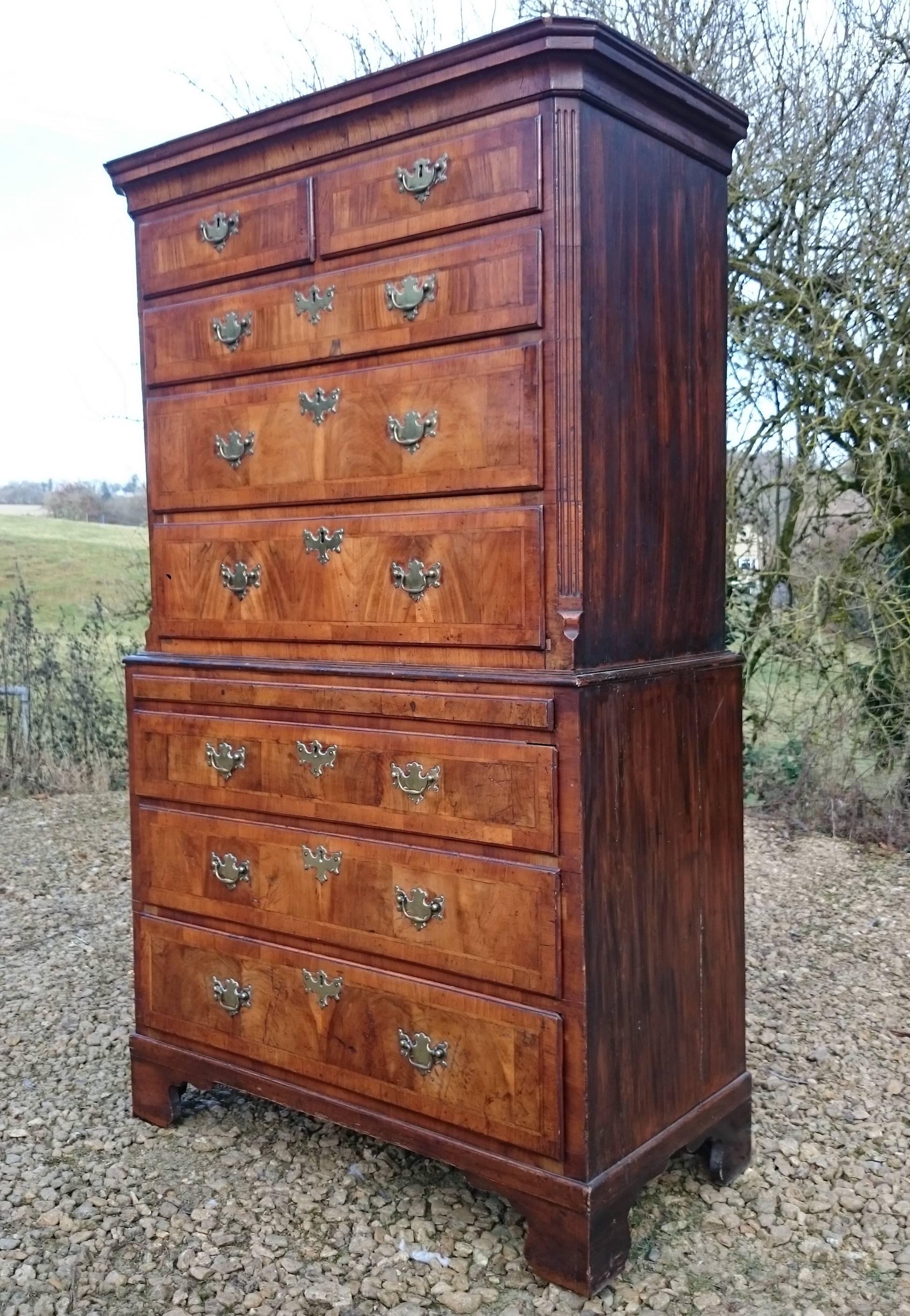 Early 18th century walnut chest on chest. This one is very good value and still has all the good stuff like graduated drawers, brushing slide, string banding and bookmatched veneers. It has the early pre-cockbeading drawer mouldings and proper oak