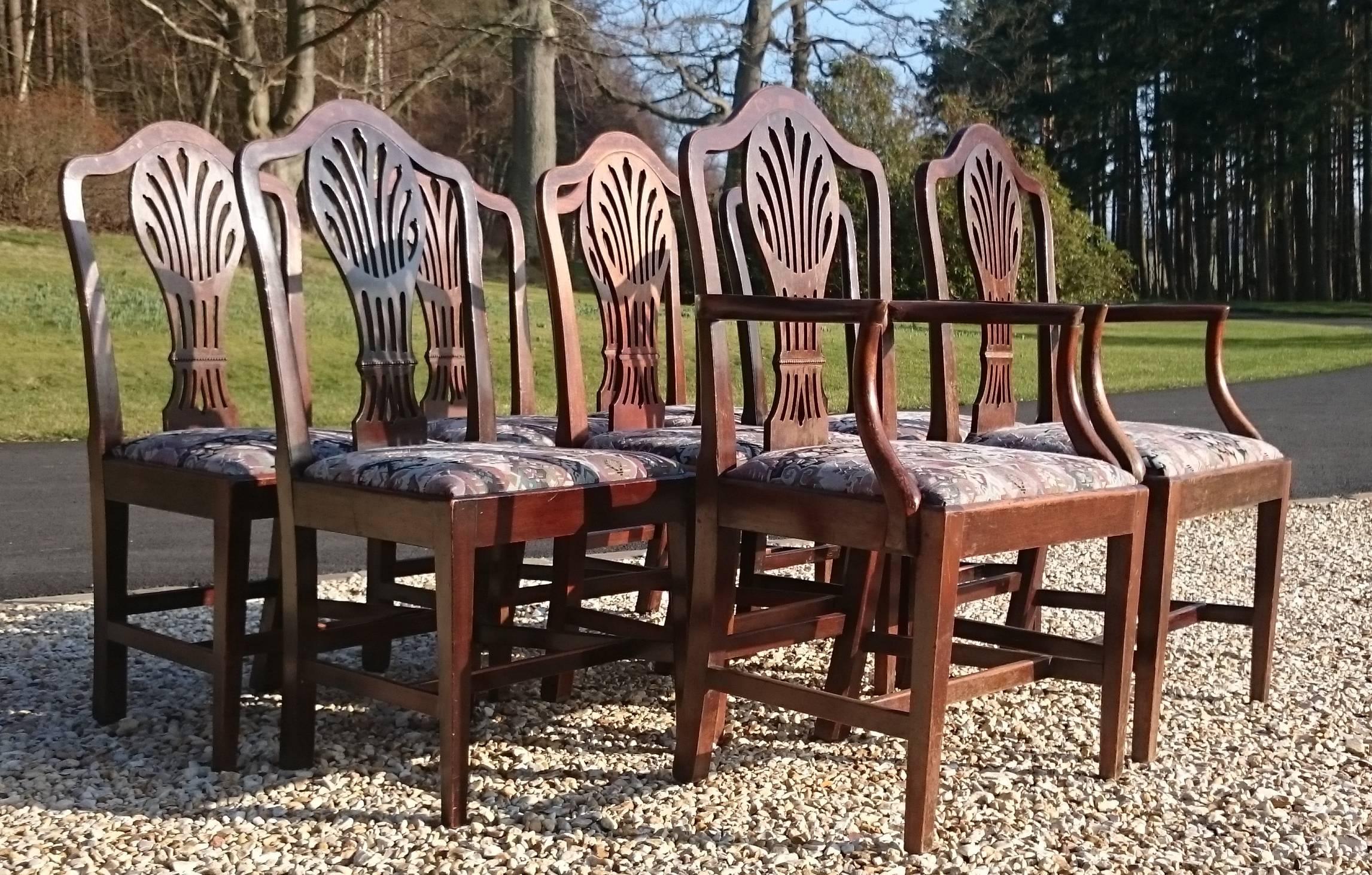 Set of eight George III period 18th century mahogany dining chairs. This is a charming set of chairs comprising six singles and two armchairs. They have good high backs for comfort and H frame stretchers for strength. The drop in seats lift out to