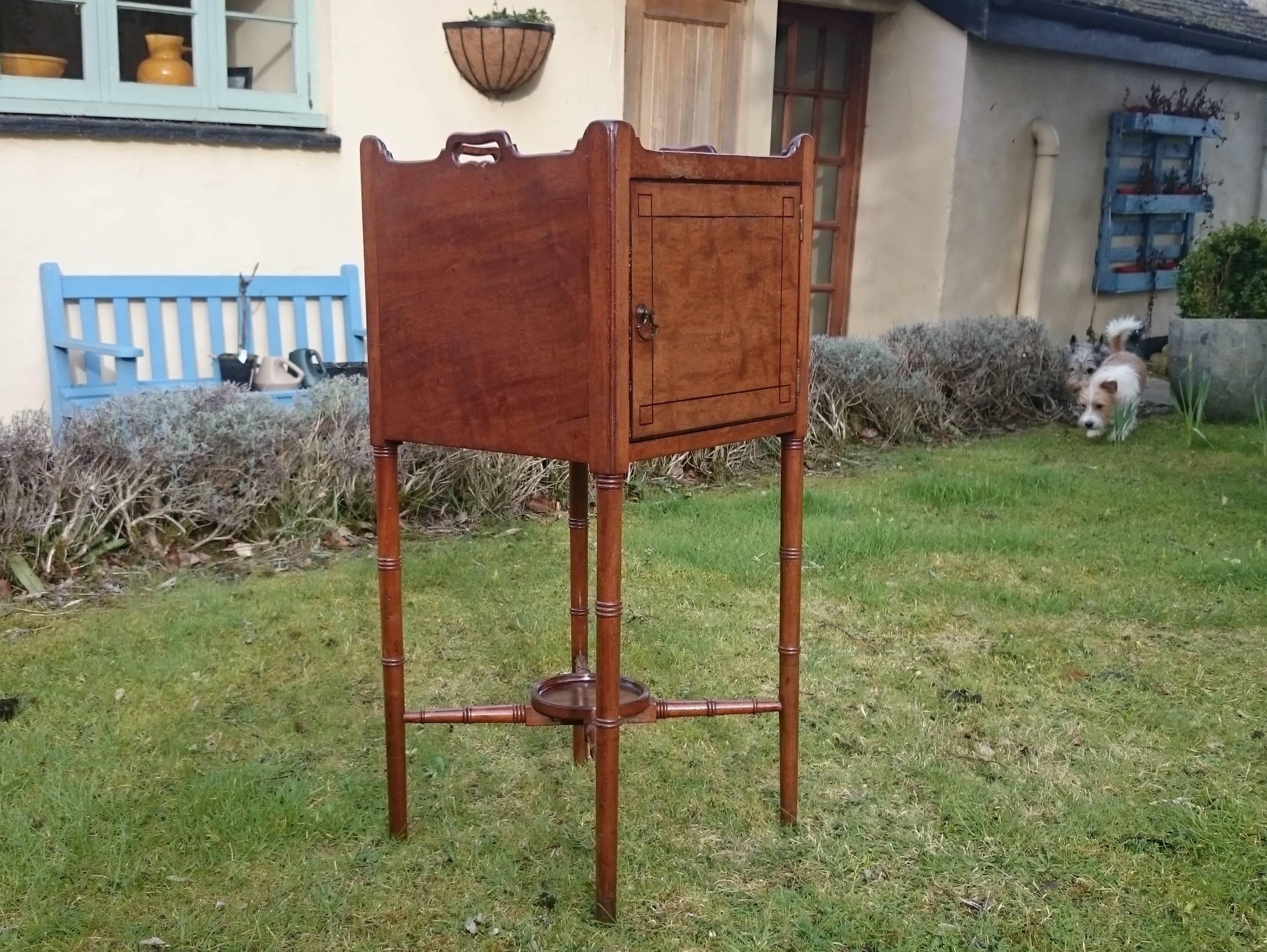 18th century George III period antique mahogany bedside cupboard. This little antique pot cupboard has some lovely details, the ebony stringing has squares at the corners, and the legs are turned to look like bamboo, as are the x frame