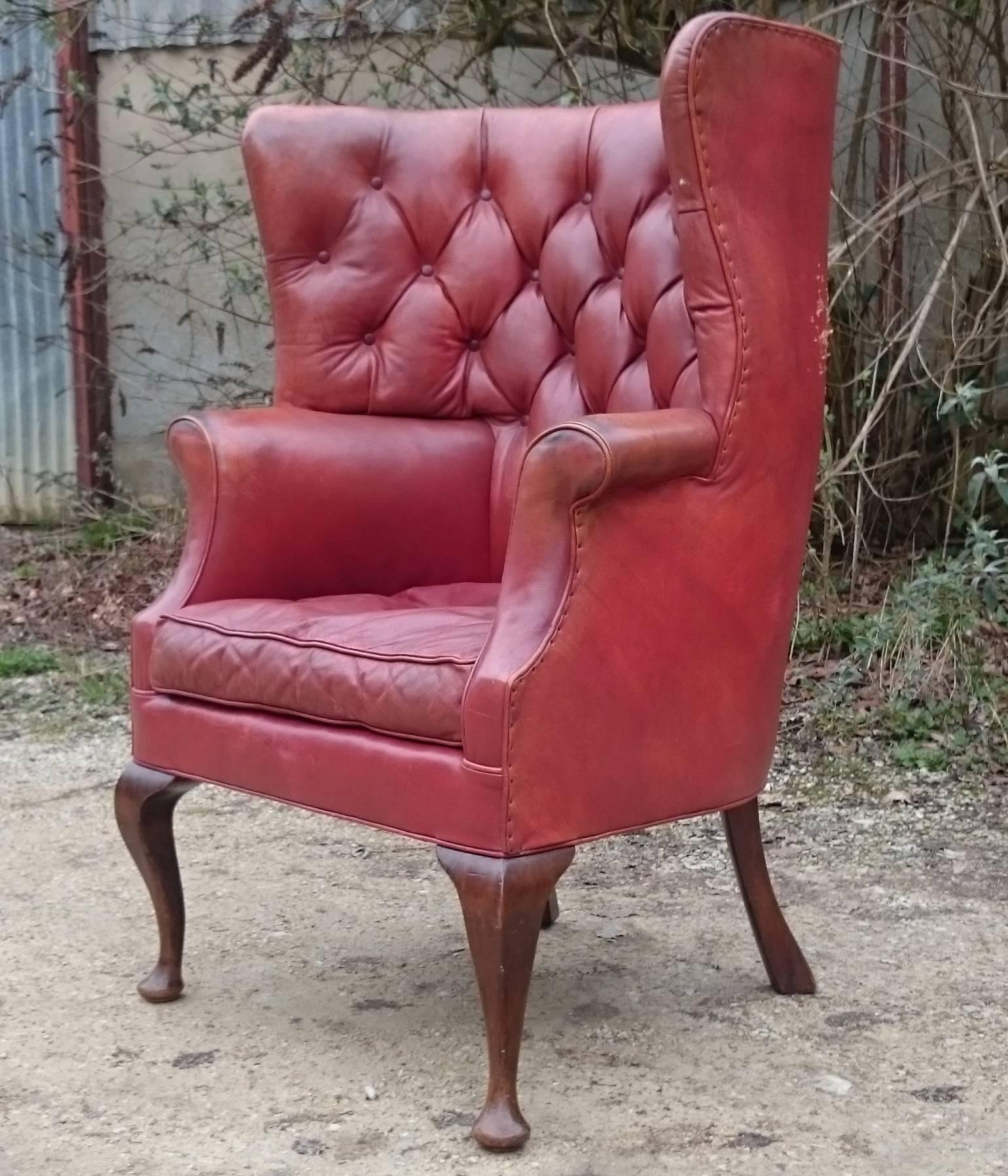 Antique barrel back and buttoned wing chair made by Howard and Sons of London upholstered in old red possibly original leather.

English circa 1910 

Measures: 76cm / 30