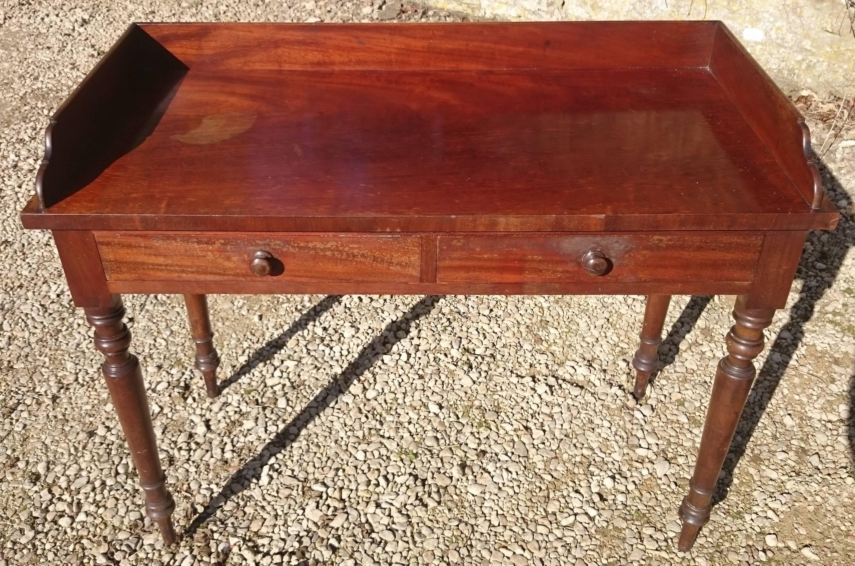 19th century mahogany serving table, side table or dressing table with gallery to stop things falling off the back. This is very useful for all applications, but especially when used as a dressing table as it stops the mirror being pushed too far