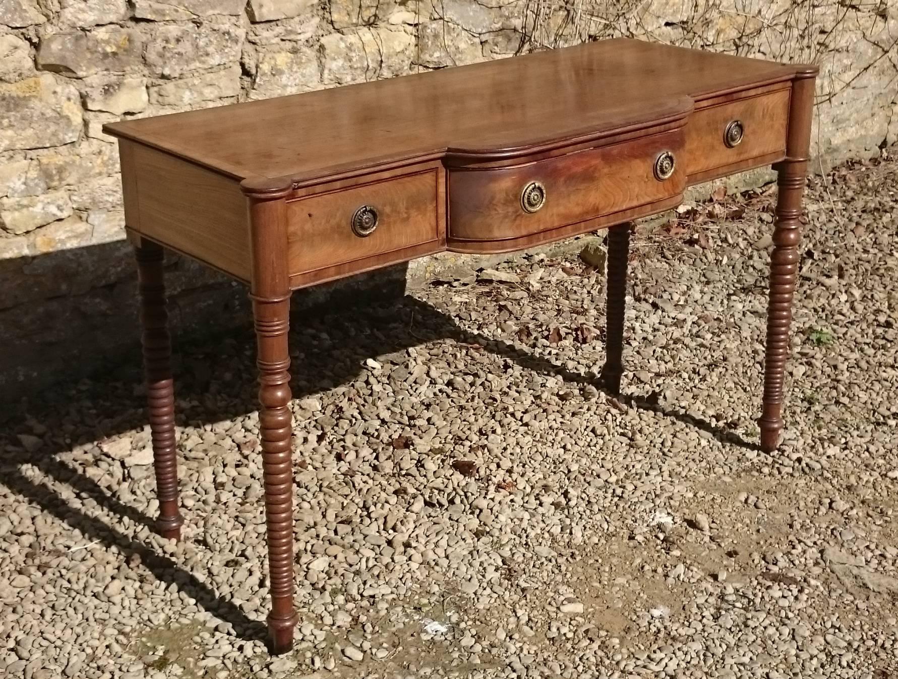 Regency mahogany antique side board or serving table. This table has faded to a fashionable pale honey colour while retaining a good patina. Photographed here before restoration, this table can be restored by our in house restorers to your