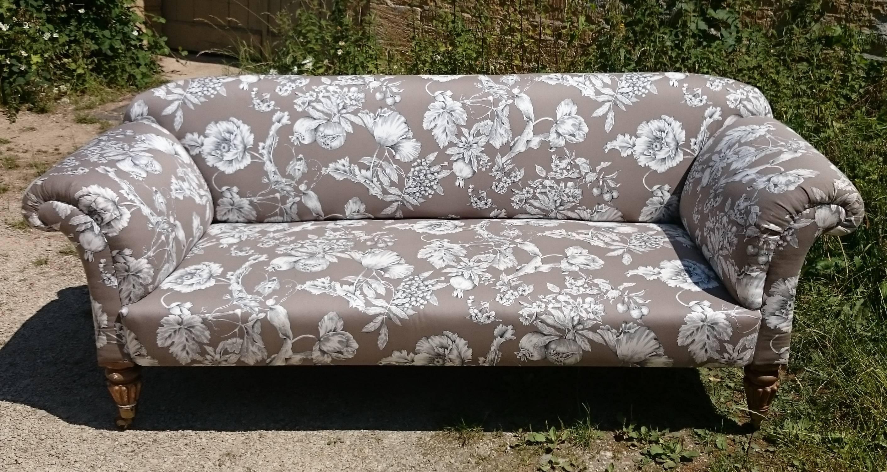 This is a very fine example of a 19th fine country house drawing room antique sofa or settee. It is a generous shape with scroll arms and gently raised back. This sofa has coiled springs which dates it to post 1828, but the legs are a good Fine