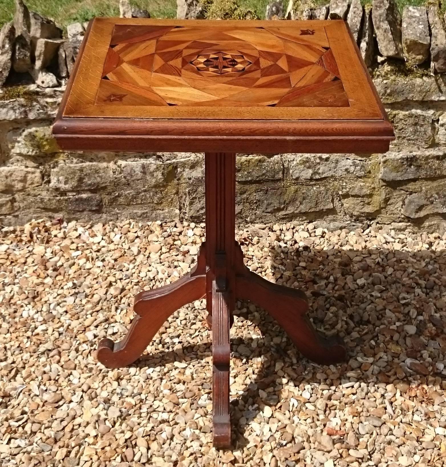 19th century antique wine table or lamp table with pine base and oak top. The pine is a good quality straight grained variety with no knots, the top is made of oak inlaid with several other timbers inlaid with marquetry in a series of concentric
