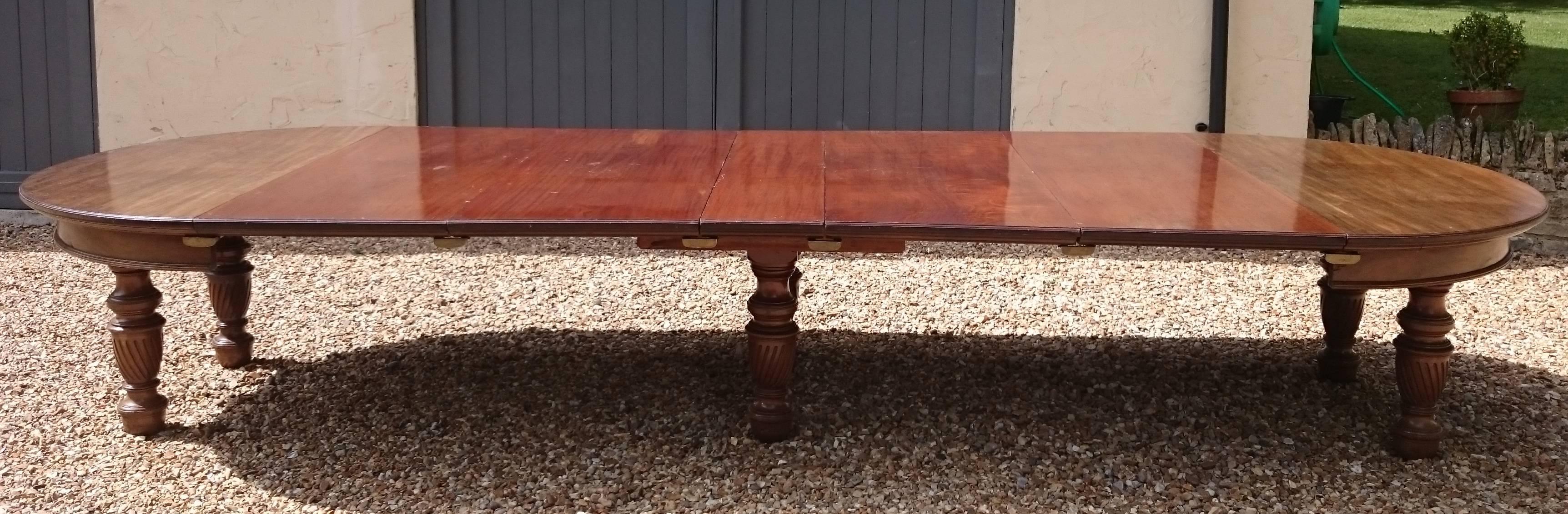 This antique dining table is exceptionally versatile and extremely well made. The top is made of huge sheets of the finest mahogany, the legs are made from single pieces of solid mahogany and even the mechanism is made from dense grained mahogany.