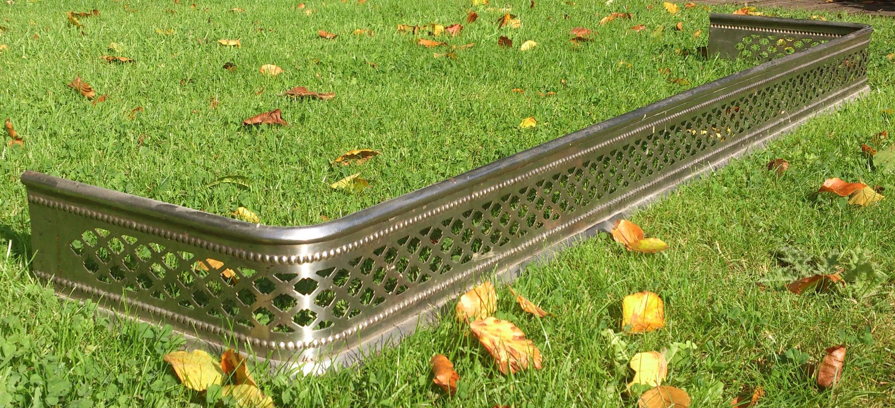 This is a very unusual fire fender being as it is an important early example of stainless steel manufacture. This is a pleasing design which is a good weight despite having intricate pierced latticework decoration. Difficult to date, but probably