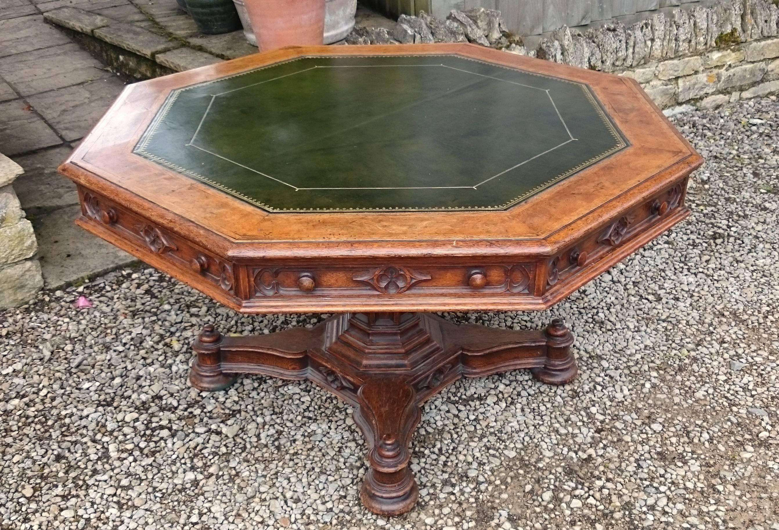 Antique centre table or library table of octagonal form. This table has drawers on four sides which are set into an elegantly thin frieze which allows for plenty of leg room. The oak is top quality with medullary rays in the solid timber and burr