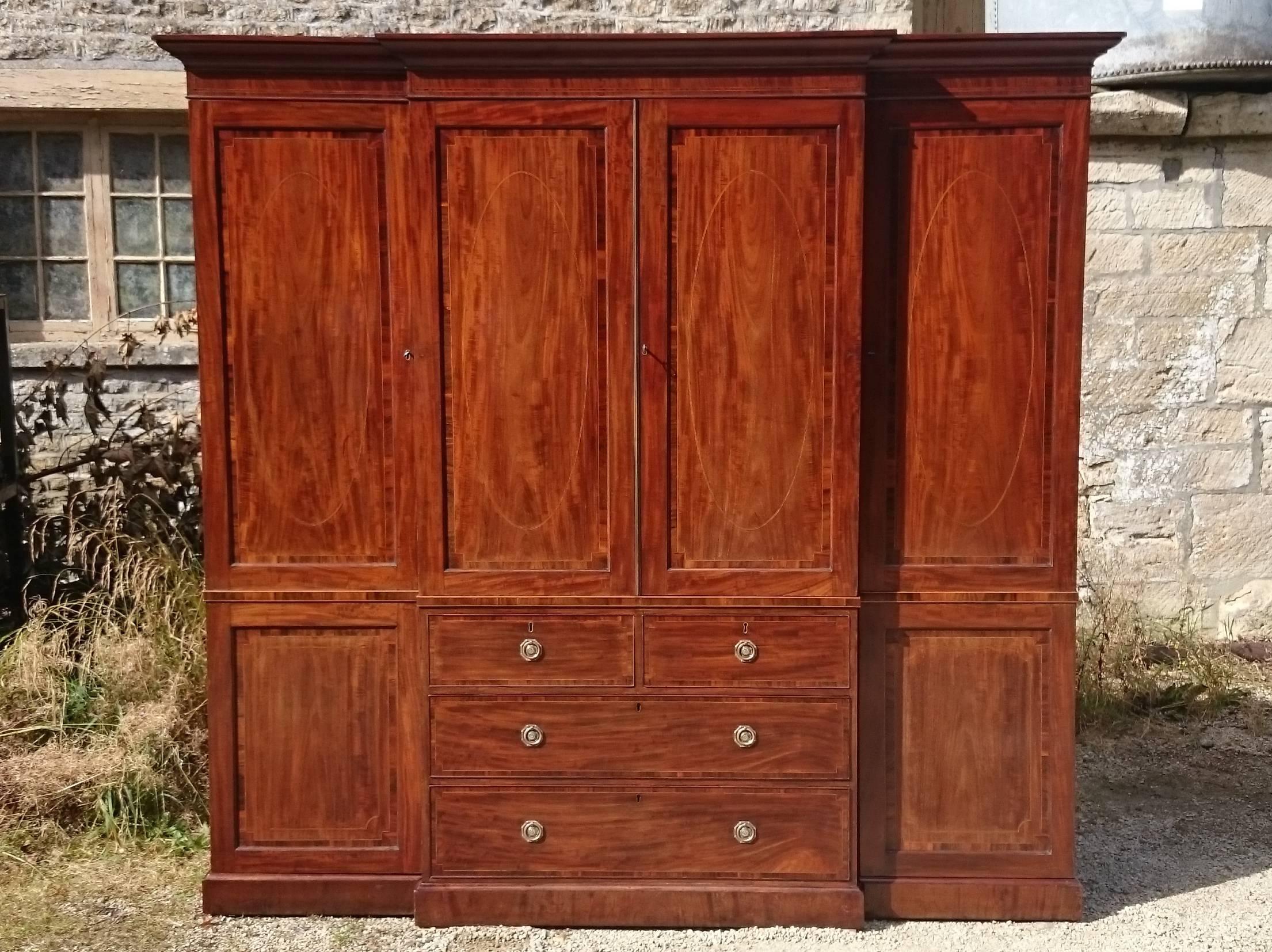 18th century antique breakfront wardrobe and linen press. This is an especially fine example of 18th century craftsmanship, all the elements are there, fine timbers, precise construction, crossbanding, stringing, dovetails, tenon joints and best