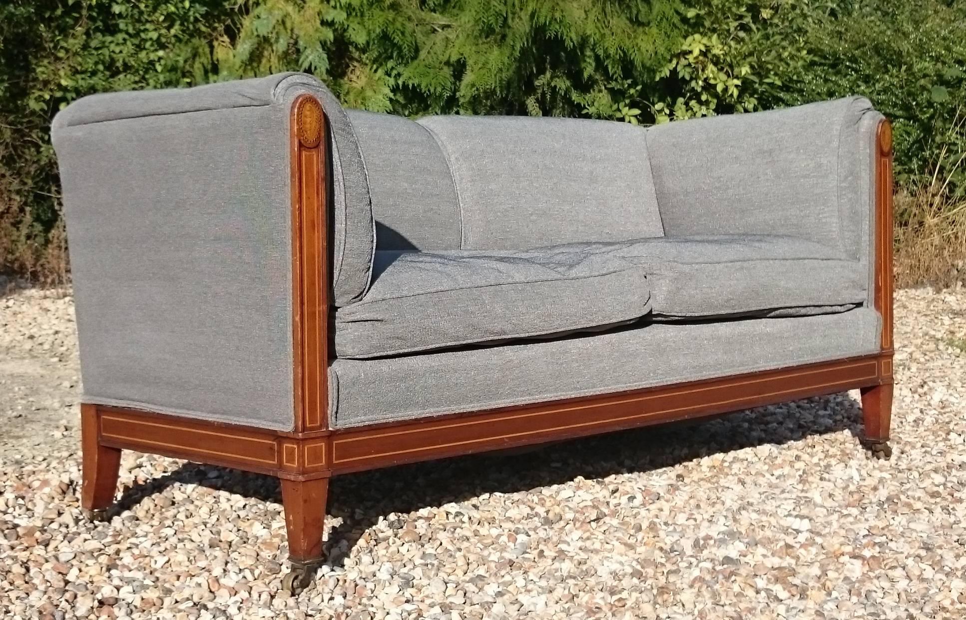 Very unusual Georgian revival sofa by Howard and Sons with mahogany show wood and box strung decoration. Howard and Sons of Berners Street in London were the foremost upholsterer of the period. They held a Royal Warrant, supplied important houses
