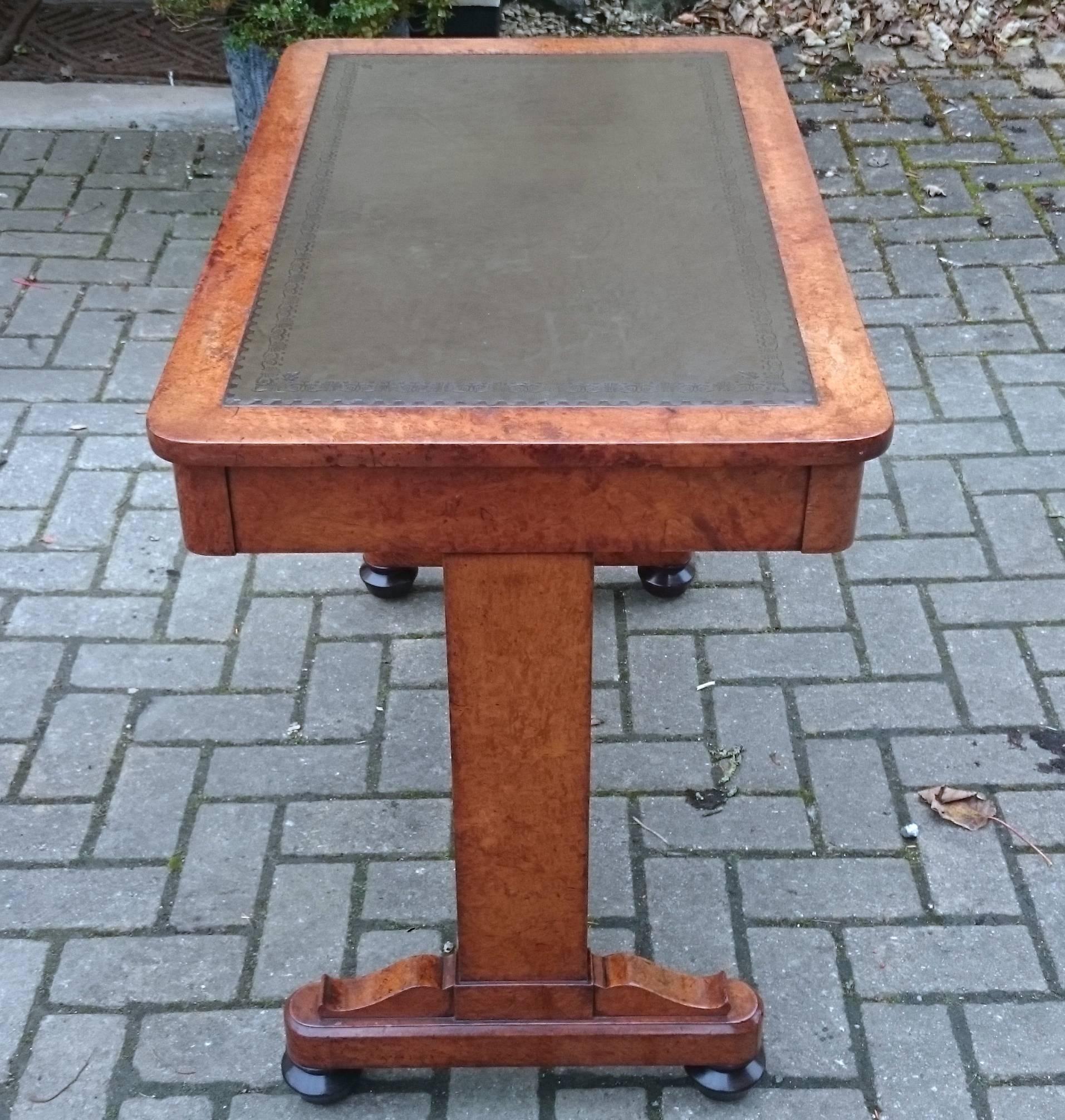 This is a charming antique writing table made of very expensive amboyna wood. The timber is a great colour, the drawers are lined with oak, there are good dovetails and a very good quality new green leather or skiver on the top. There are two