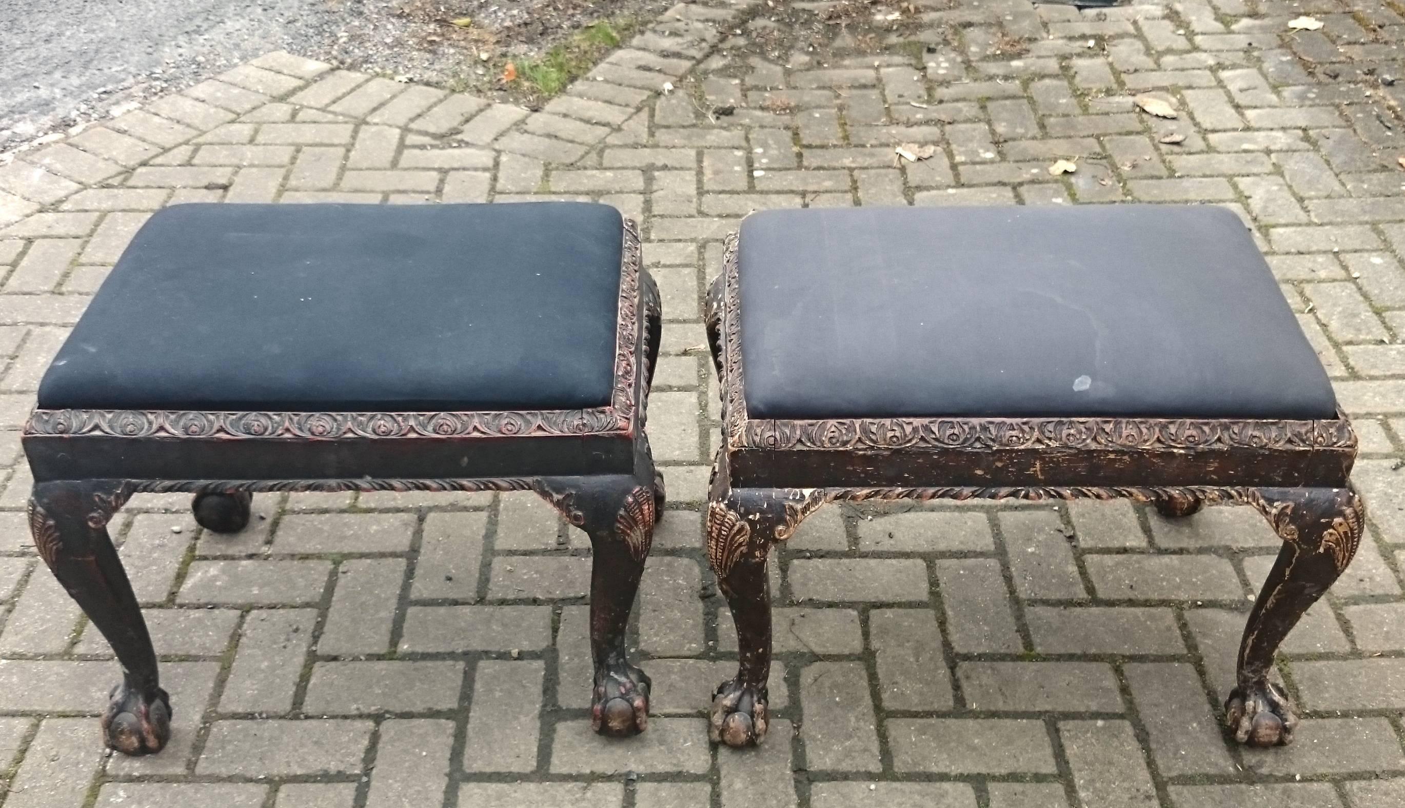 Pair of four legged jointed wooden antique stools with cabriole legs and carved decoration. This pair of stools has faded and worn paint and what is sometimes described as shabby chic. Regardless of the description, these two stools have a charm