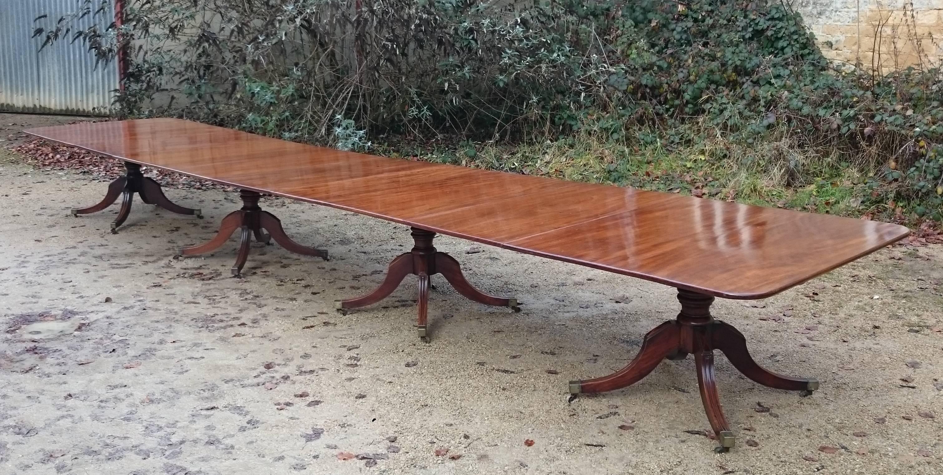 This early 19th century antique three pedestal dining table has been extended to a massive 20 foot (244