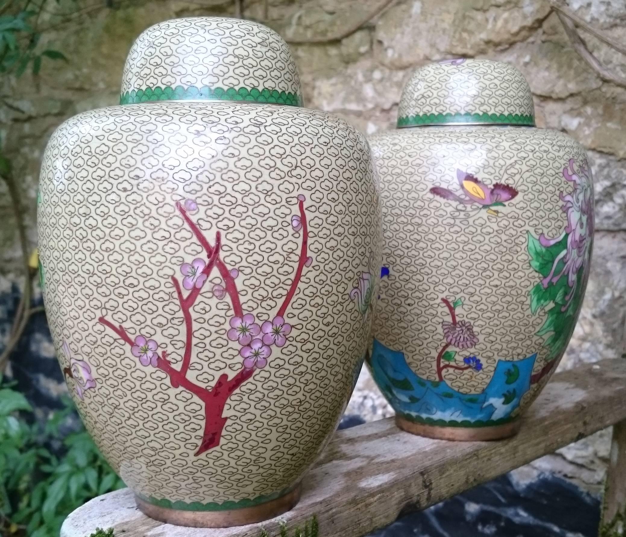Pair of Chinese cloisonné enamel ginger jars with lids. This pair of jars are in very good condition with very detailed cloisonné work. The decoration on the jars are a mirror image rather than being identical, this is a good sign of quality as a