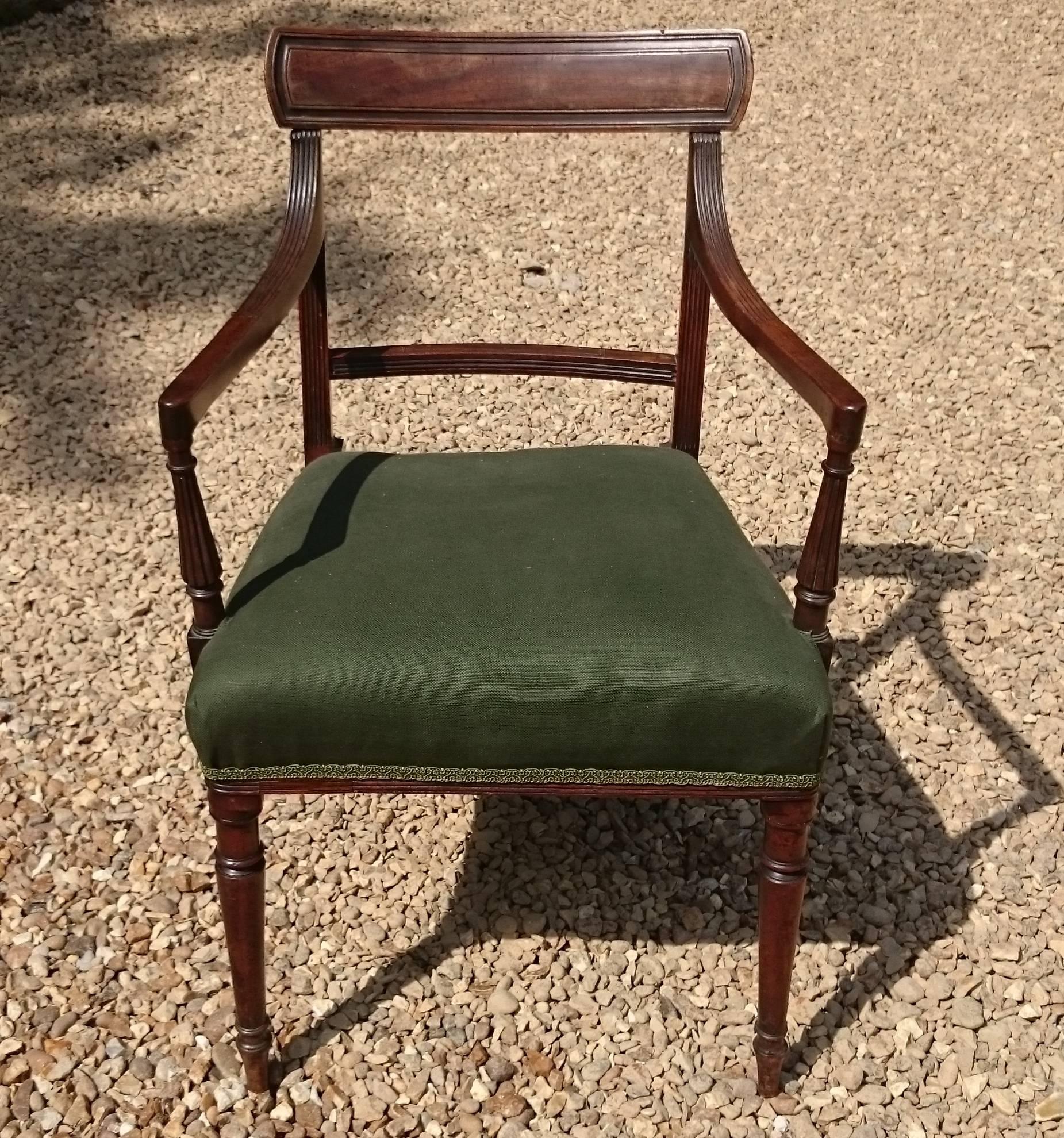 Early 19th century mahogany George III period antique armchair or desk chair. This chair has the elegant proportions of the very early 19th century, the reeding is close together and the legs are slender and finely turned. The construction at this