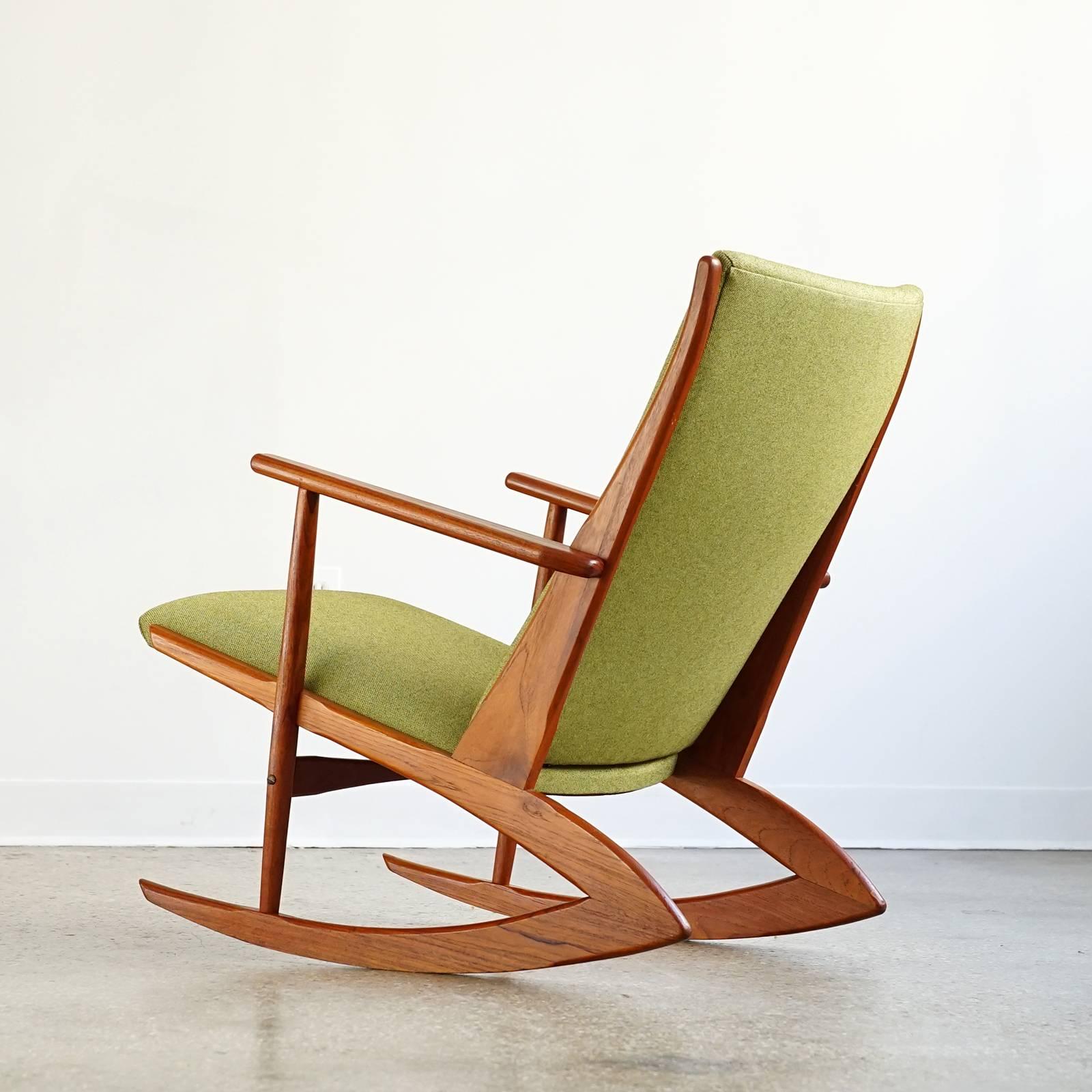Iconic Danish rocking chair reupholstered in green Knoll Hourglass fabric. Solid teak frame is clean and sturdy with rich tone and grain. Invisible concrete counter weight concealed in the front of the seat allow the rockers to have a shorter, more