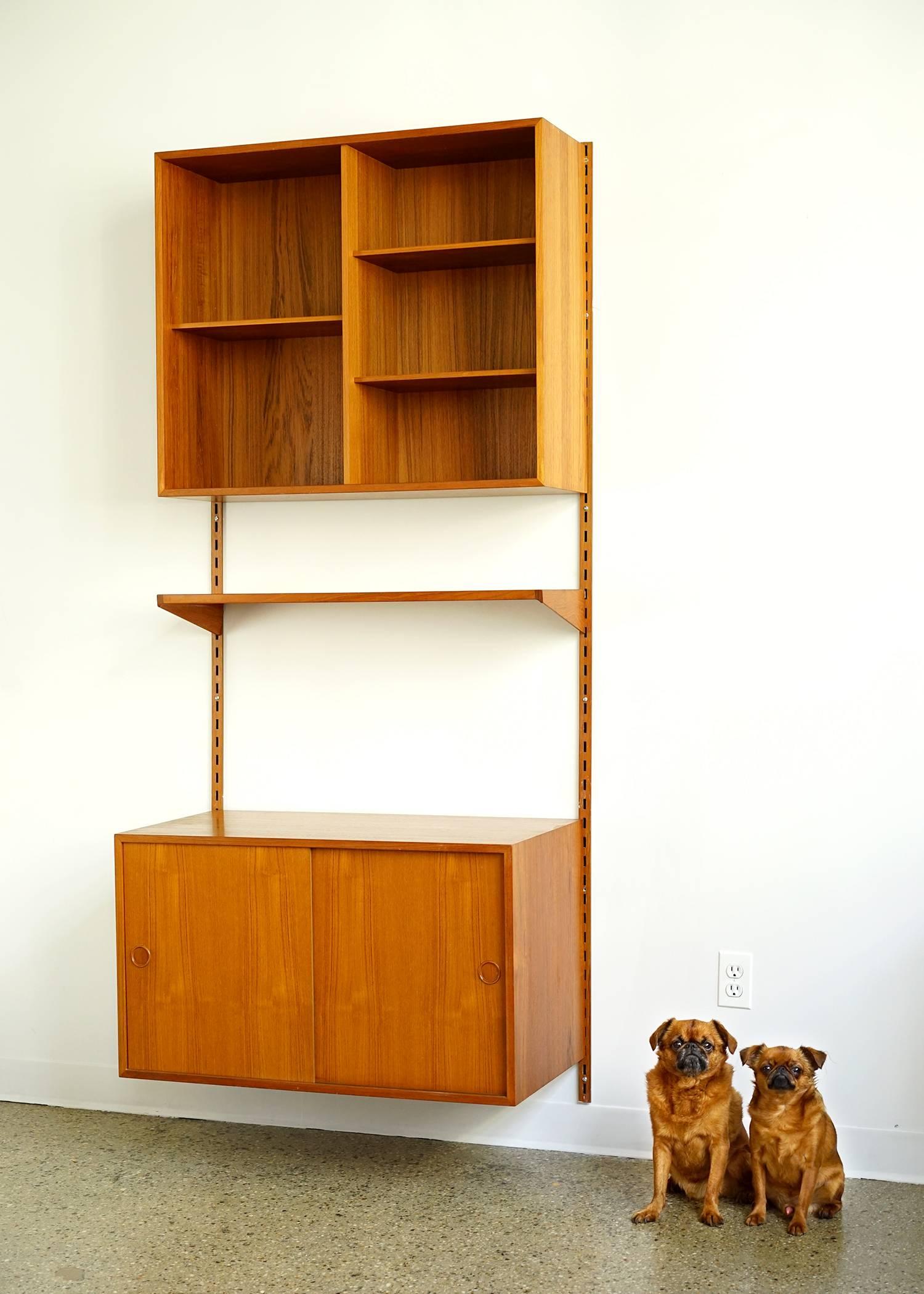 Three components mounted on vertical rails which allow adjustable height and arrangement. Teak construction with original finish in good condition. Interior shelves are adjustable. Handsome and functional.
Measures:
Open shelves: W 33.75