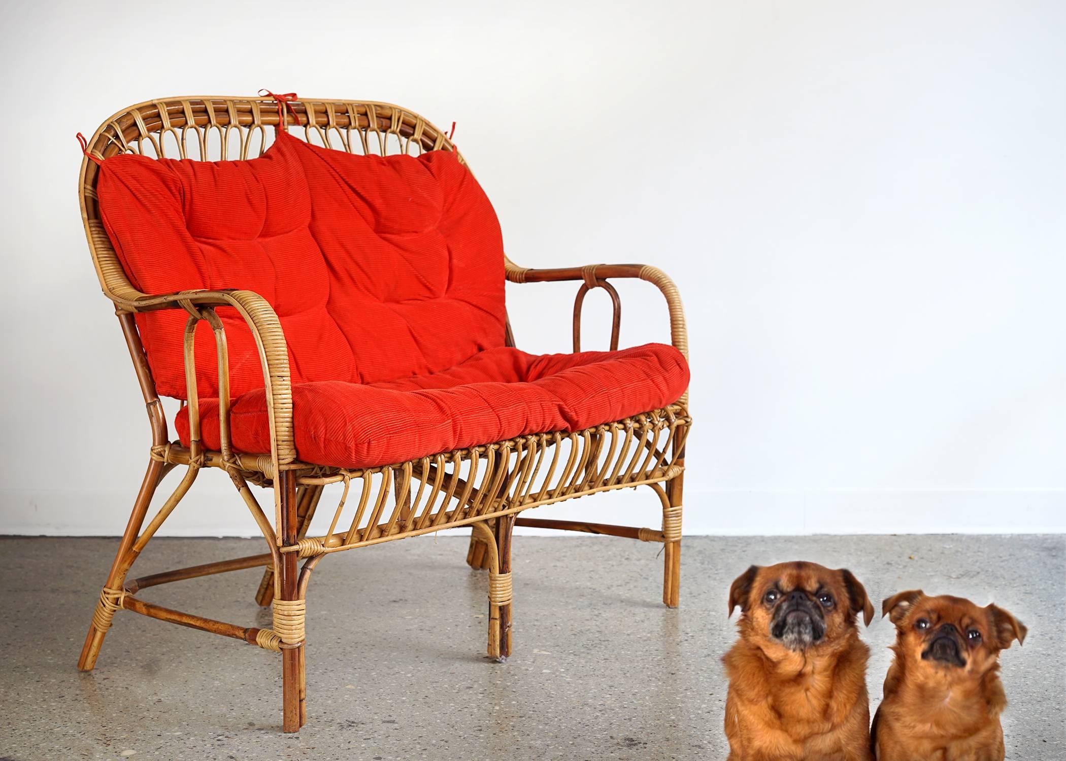 Lovely sculptural frame with charming proportions. Its light weight and airy appearance belie its strength and sturdiness. Original red corduroy cushions.