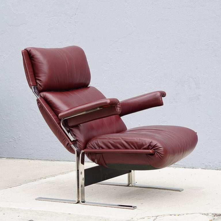Cantilevered stainless steel frame with bright polished surface. Soft cushions featuring original plum-burgundy leather. Comfortable, reclined seating position. The frame is strong and sturdy yet flexes with your movement. High quality production.